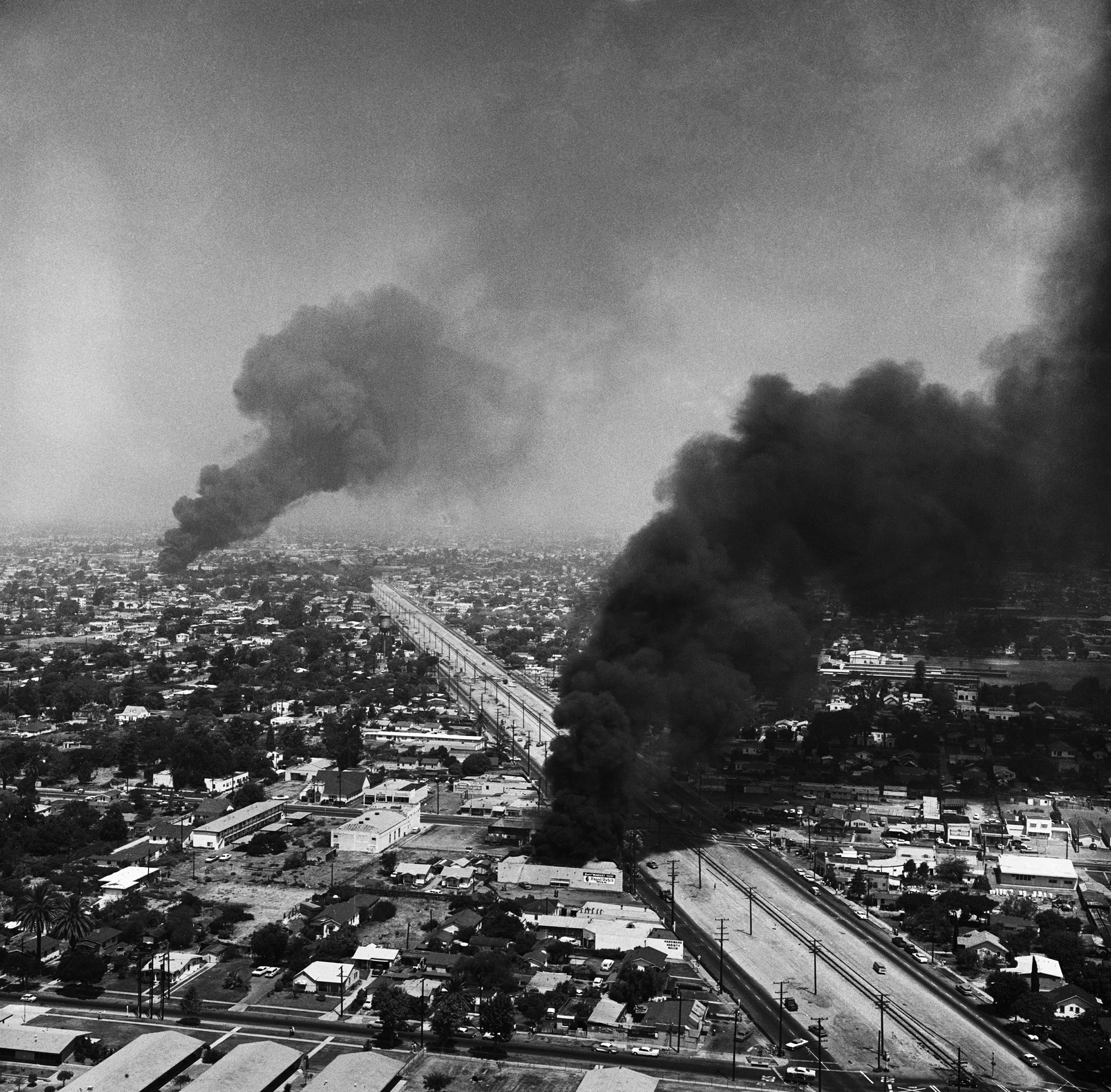 Black smoke darkens the sky over Southeast Los Angeles, during the fourth day of rioting in the area on Aug. 16, 1965 (Bettmann Archive/Getty Images)