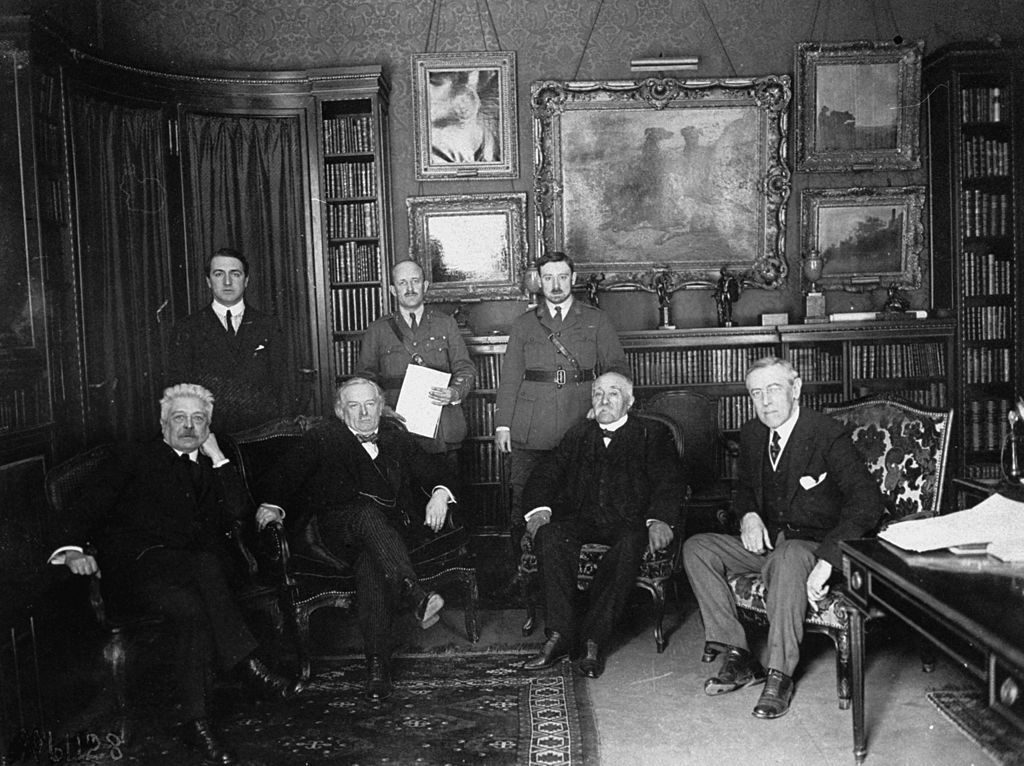 1919 Peace Conference attendees (seated, L-R) Italian Premier Vittorio Orlando, British Prime Minister David Lloyd George, French Premier Georges Clemenceau, U.S. President Woodrow Wilson meeting in Paris prior to the signing of the Versailles Treaty. (US Army Signal Corps/The LIFE Picture Collection—Getty Images)