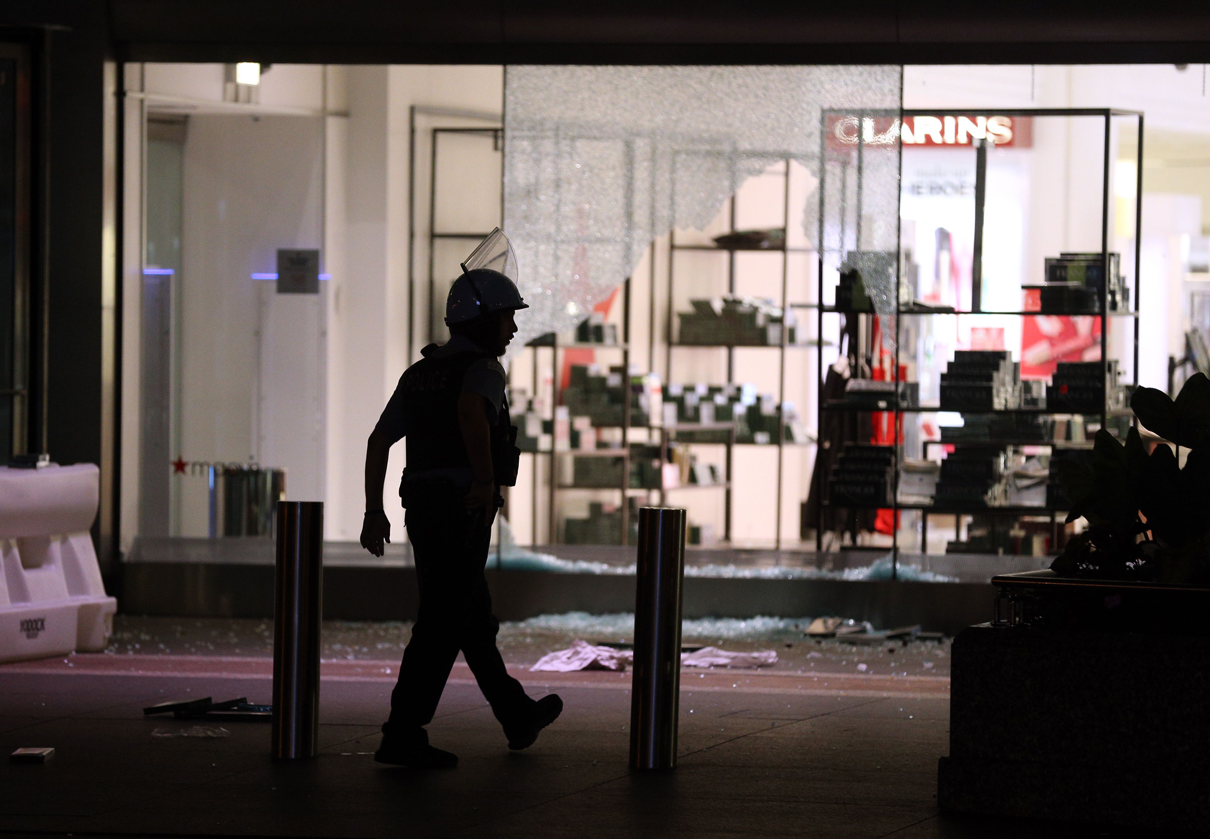 A Chicago Police officer walks past Macy's on North Michigan Avenue in Chicago after the store and others in the area were looted early Monday Aug. 10, 2020. (Terrence Antonio James—Chicago Tribune/TNS/Sipa)