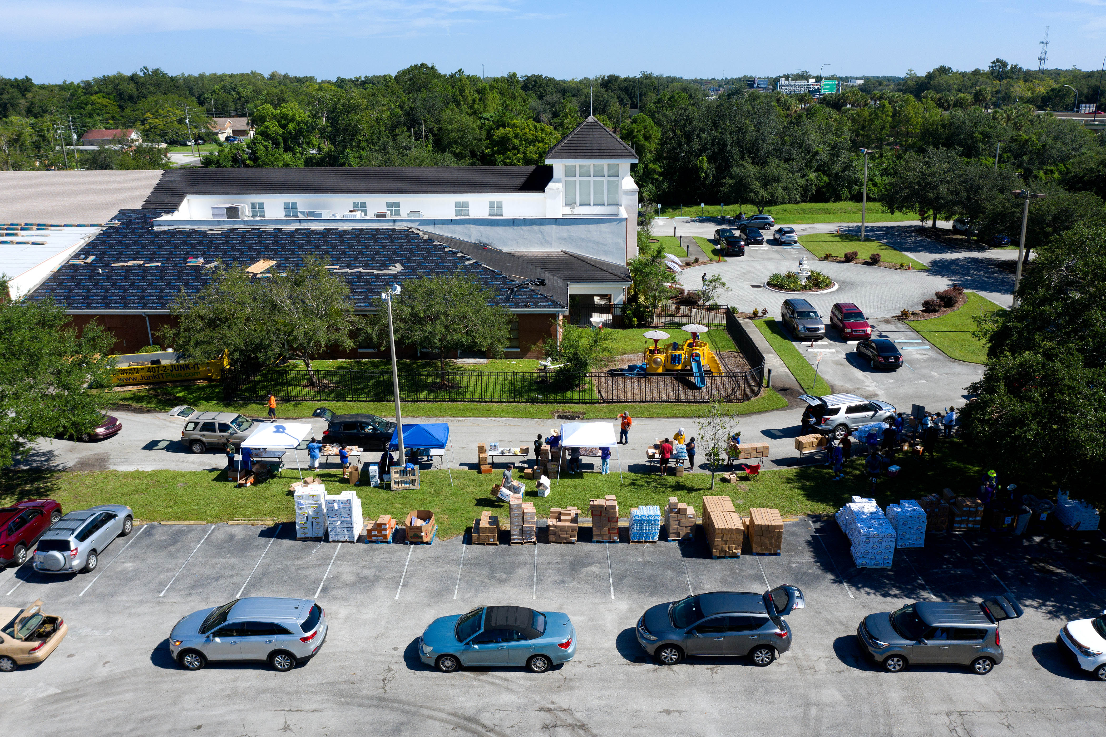Cars line up to receive food from the Second Harvest Food Bank of Central Florida at Carter Tabernacle Christian Methodist Episcopal Church on Aug. 8, 2020 in Orlando. (Paul Hennessy—NurPhoto/Getty Images)