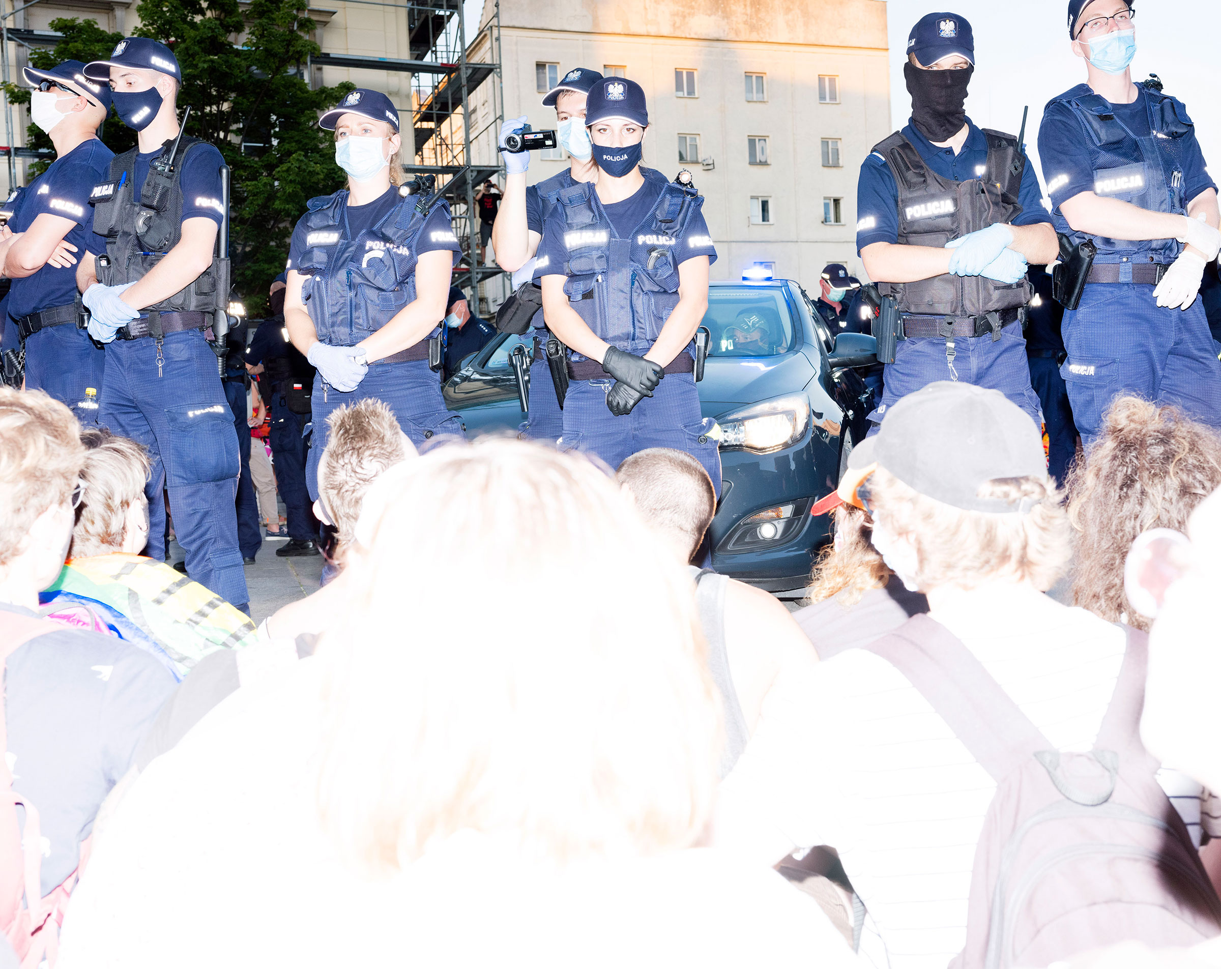 Protestors sit in front of police on in Warsaw, Poland Aug. 7, 2020.