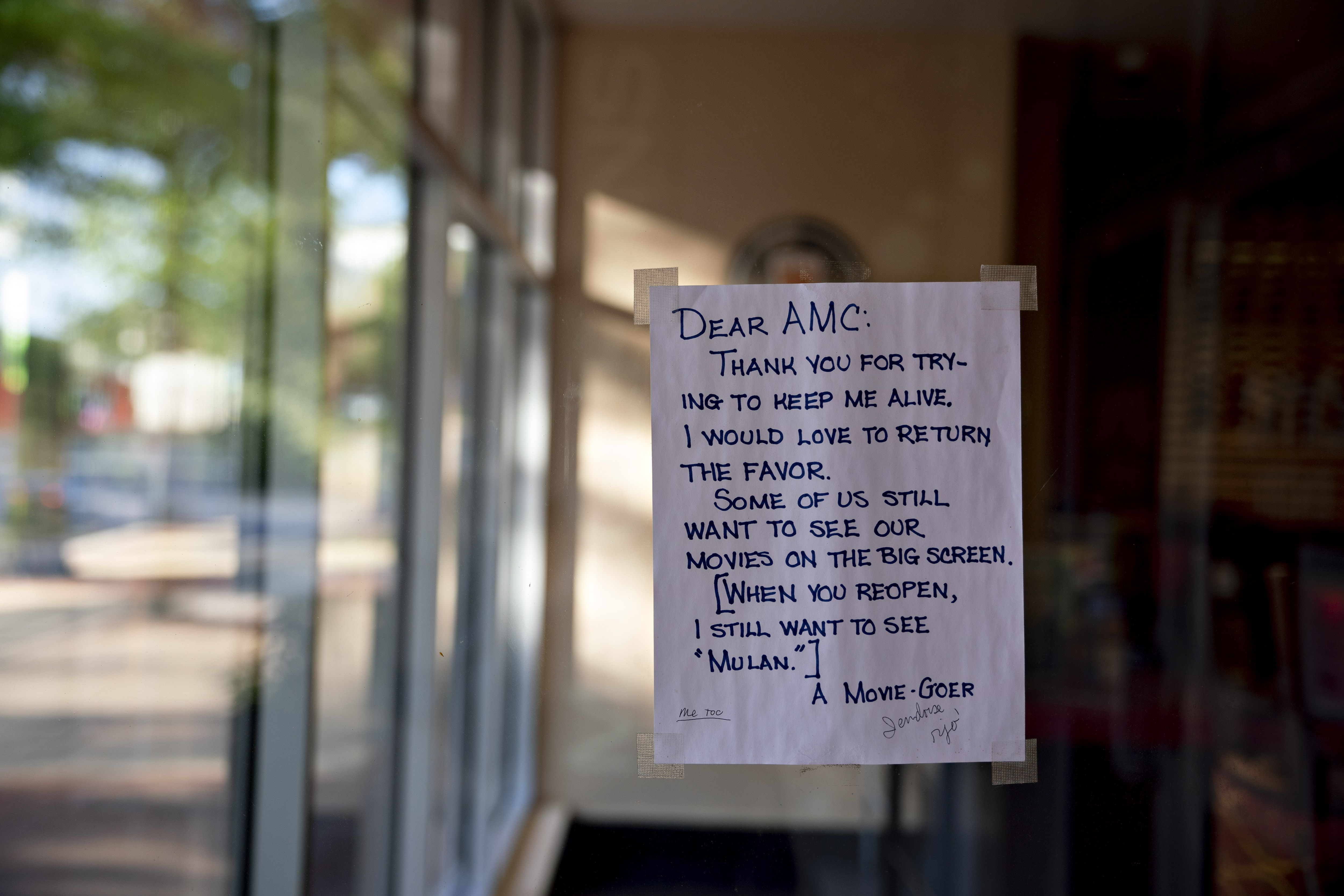 A hand-written letter by a Movie-Goer hangs on the window of an AMC Entertainment Holdings Inc. movie theater in Arlington, Virginia, U.S., on Monday, June 8, 2020.