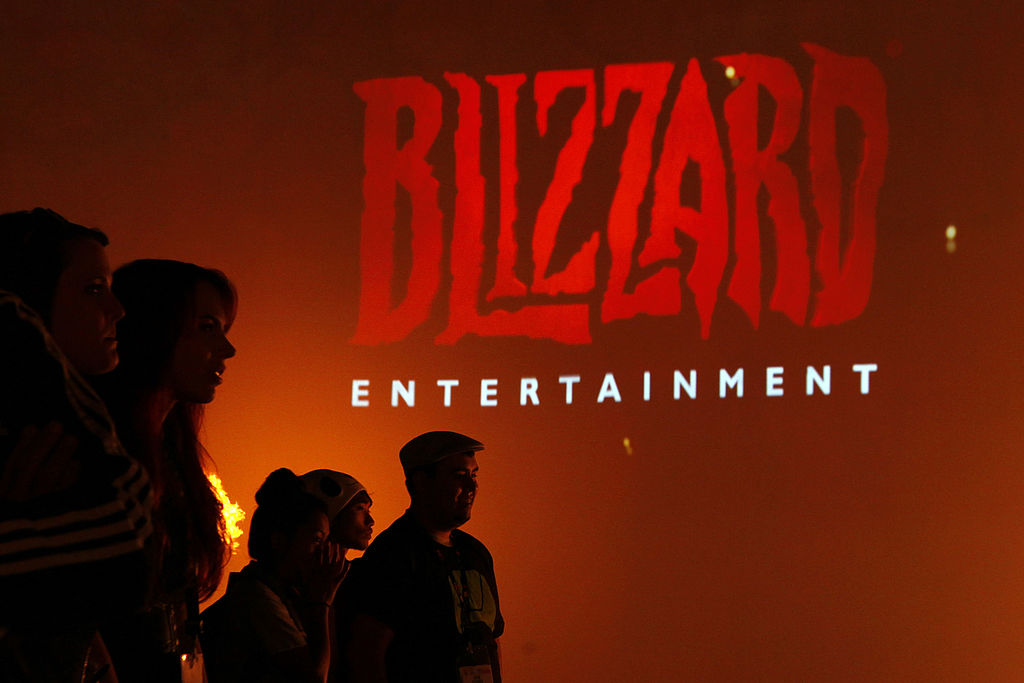 Attendees stand in front of the logo for Blizzard Entertainment Inc., a unit of Activision Blizzard Inc., as they watch a trailer for the company's Diablo III video game during the E3 Electronic Entertainment Expo in Los Angeles, California, U.S., on Wednesday, June 12, 2013. E3, a trade show for computer and video games, draws professionals to experience the future of interactive entertainment as well as to see new technologies and never-before-seen products. (Patrick T. Fallon/Bloomberg–Getty Images)