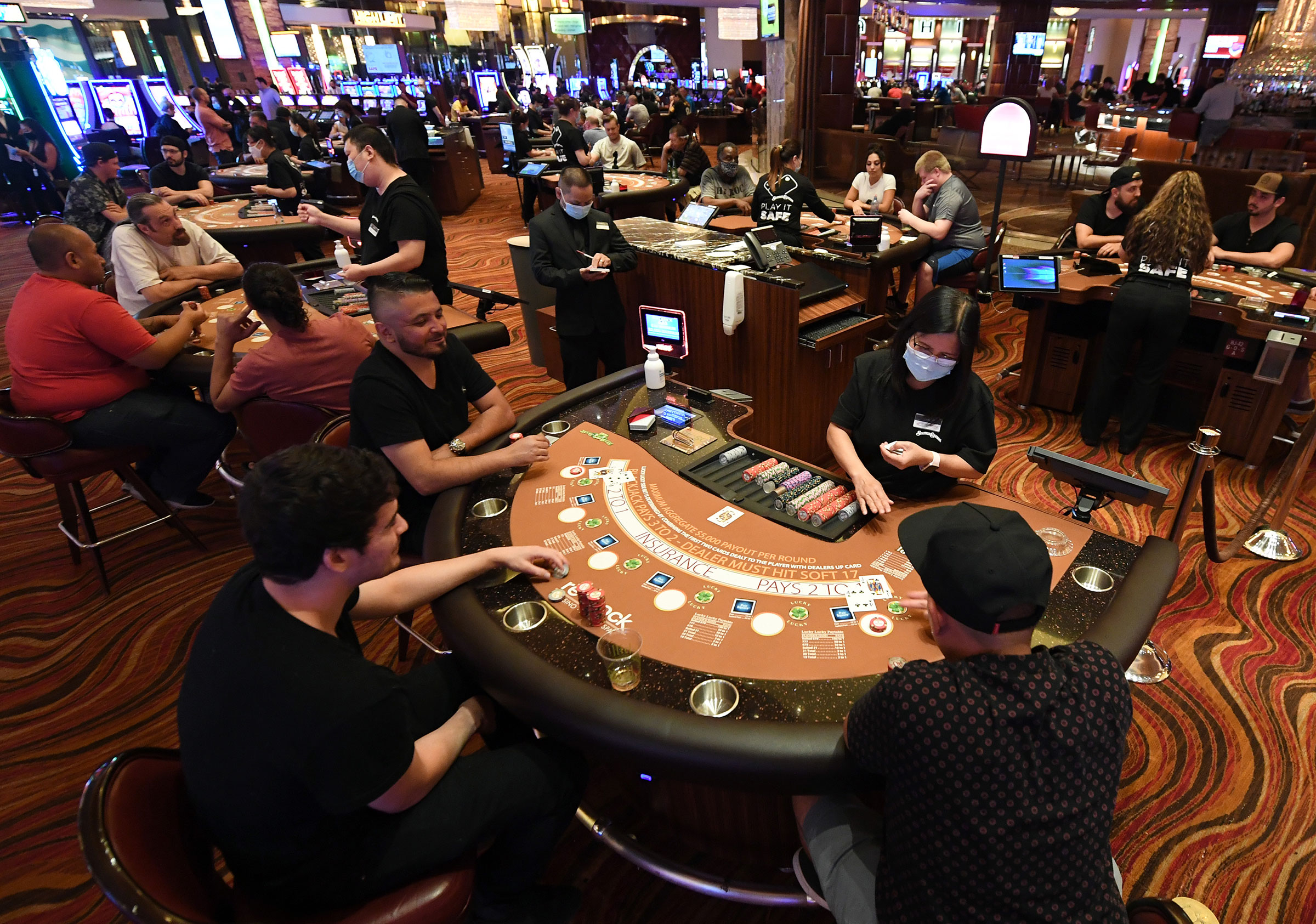 Guests play blackjack at tables with only three players allowed at a time at the Red Rock Resort after the property opened for the first time since being closed on March 17 because of the coronavirus pandemic on June 4, 2020 in Las Vegas, Nevada. (Ethan Miller—Getty Images)
