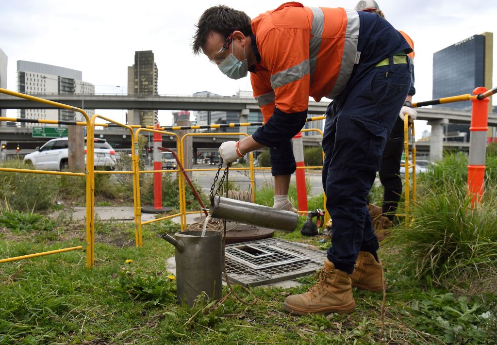 This photo taken on May 19, 2020 shows hydrographer Steven Paull taking samples from a sewer in Melbourne. (William West–AFP/Getty Images)