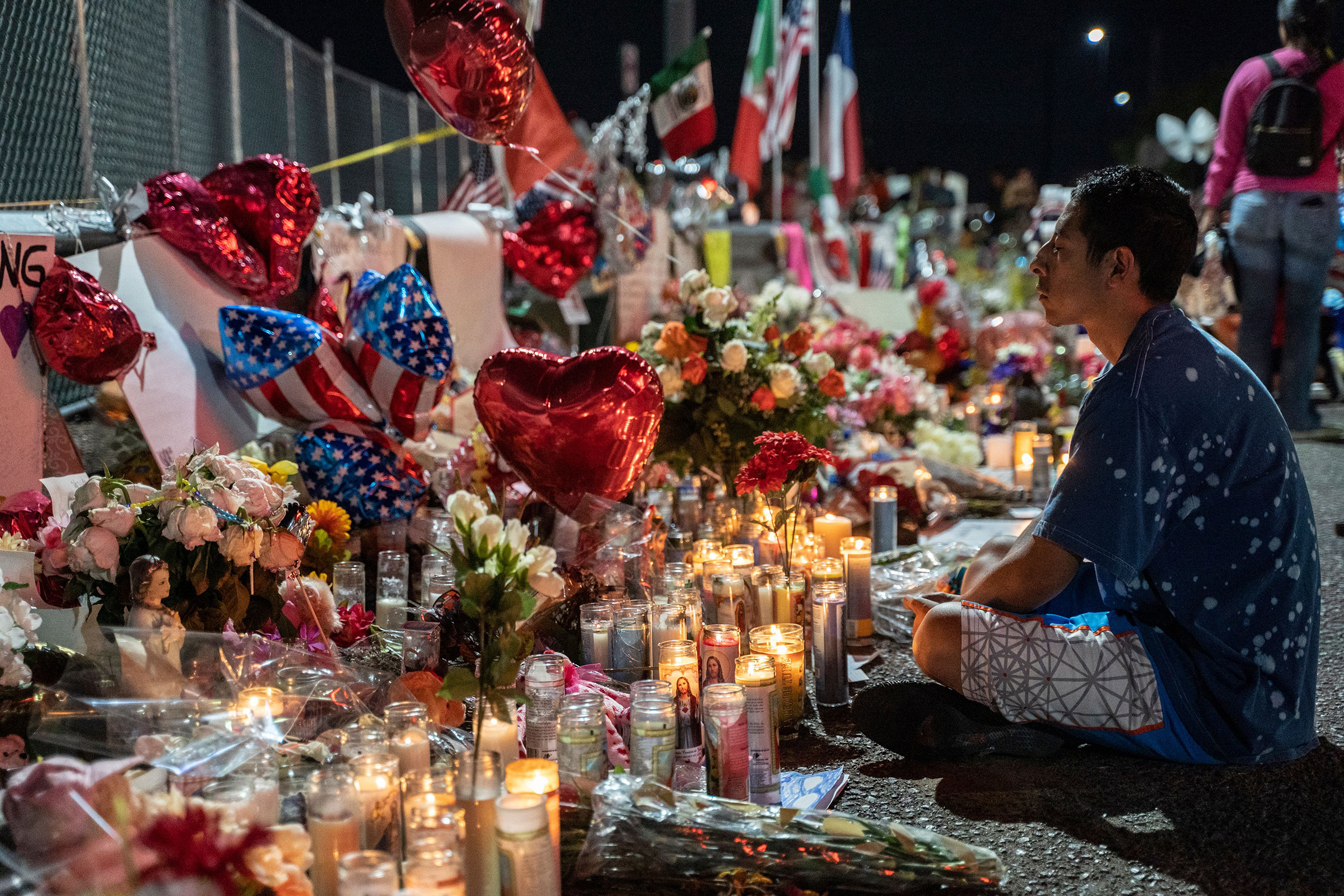 Abel Valenzuela meditates in front of the makeshift memorial for shooting victims at the Cielo Vista Mall Walmart in El Paso, Texas on August 8, 2019. (Paul Ratje—AFP via Getty Images)