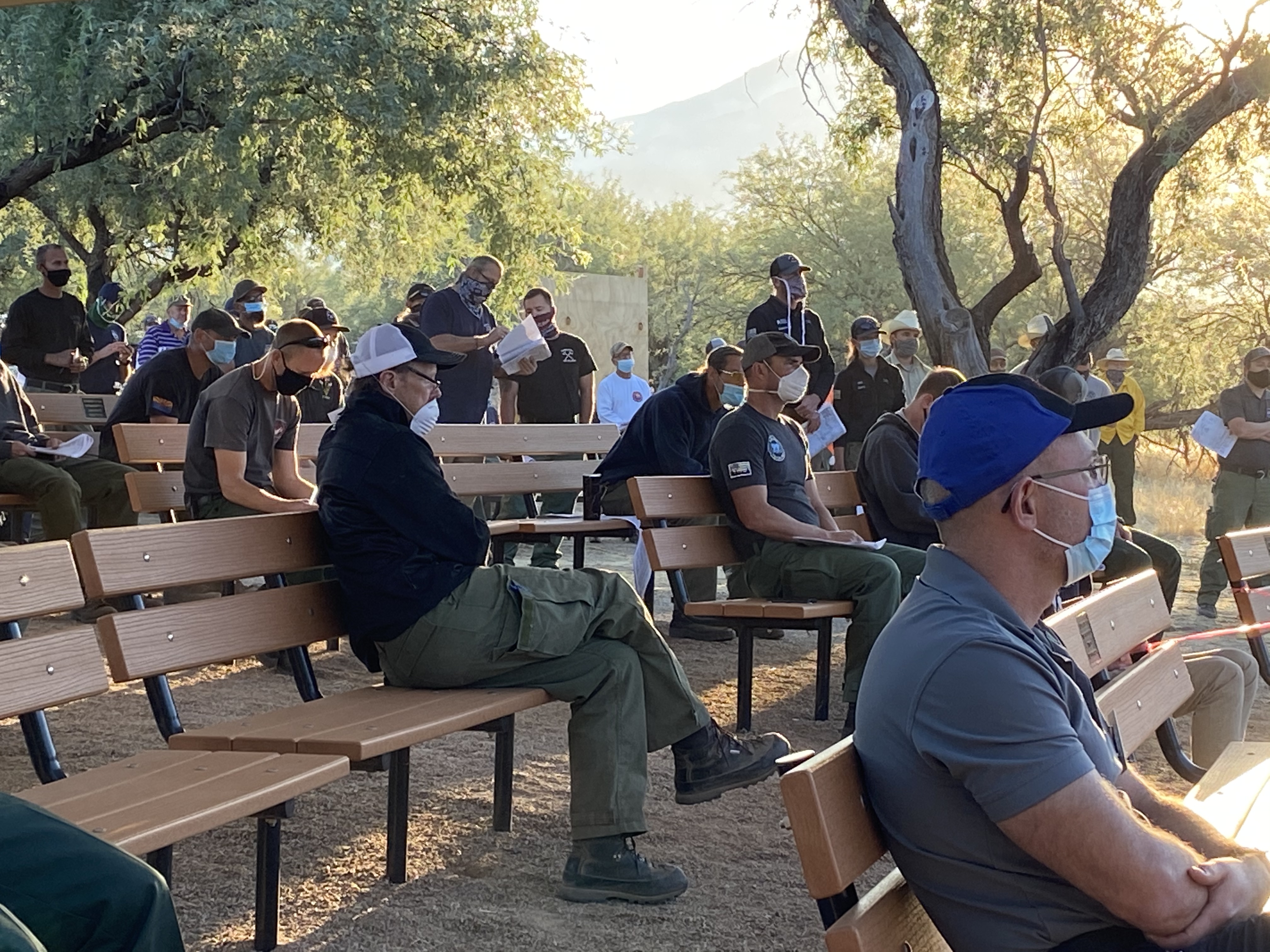 Firefighters wear face masks at a morning briefing on the Bighorn Fire, north of Tucson, Ariz., on June 22, 2020.