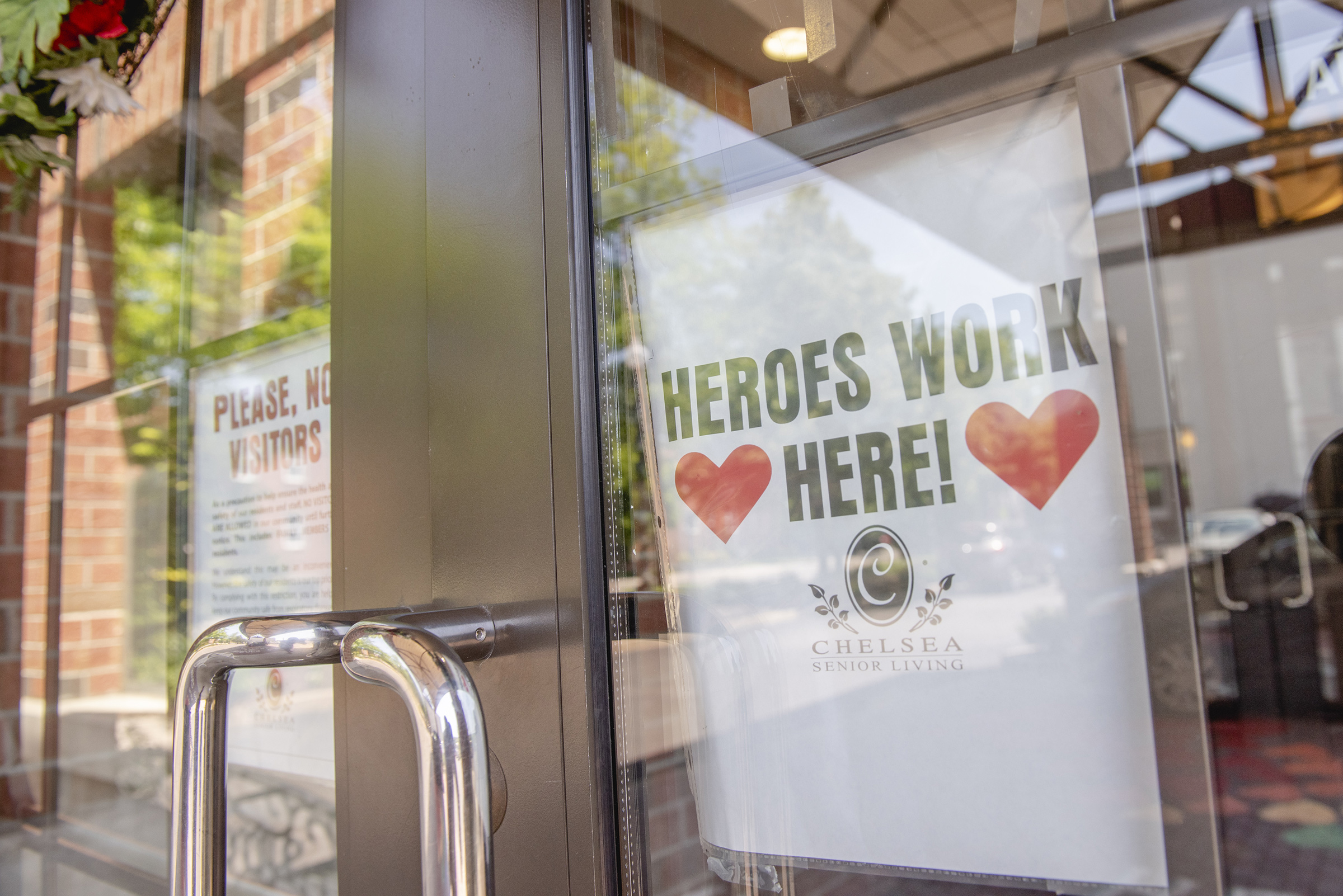 A sign reading "Heroes Work Here" is displayed in a window of the Maple Pointe Assisted Living facility in Rockville Centre, New York, on June 9 (Johnny Milano—Bloomberg/Getty Images)