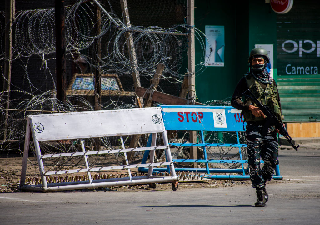An Indian paramilitary trooper stands guard in front of his bunker in the city of Srinagar in Indian administered-Kashmir on August 5, 2020. (Yawar Nazir/Getty Images)