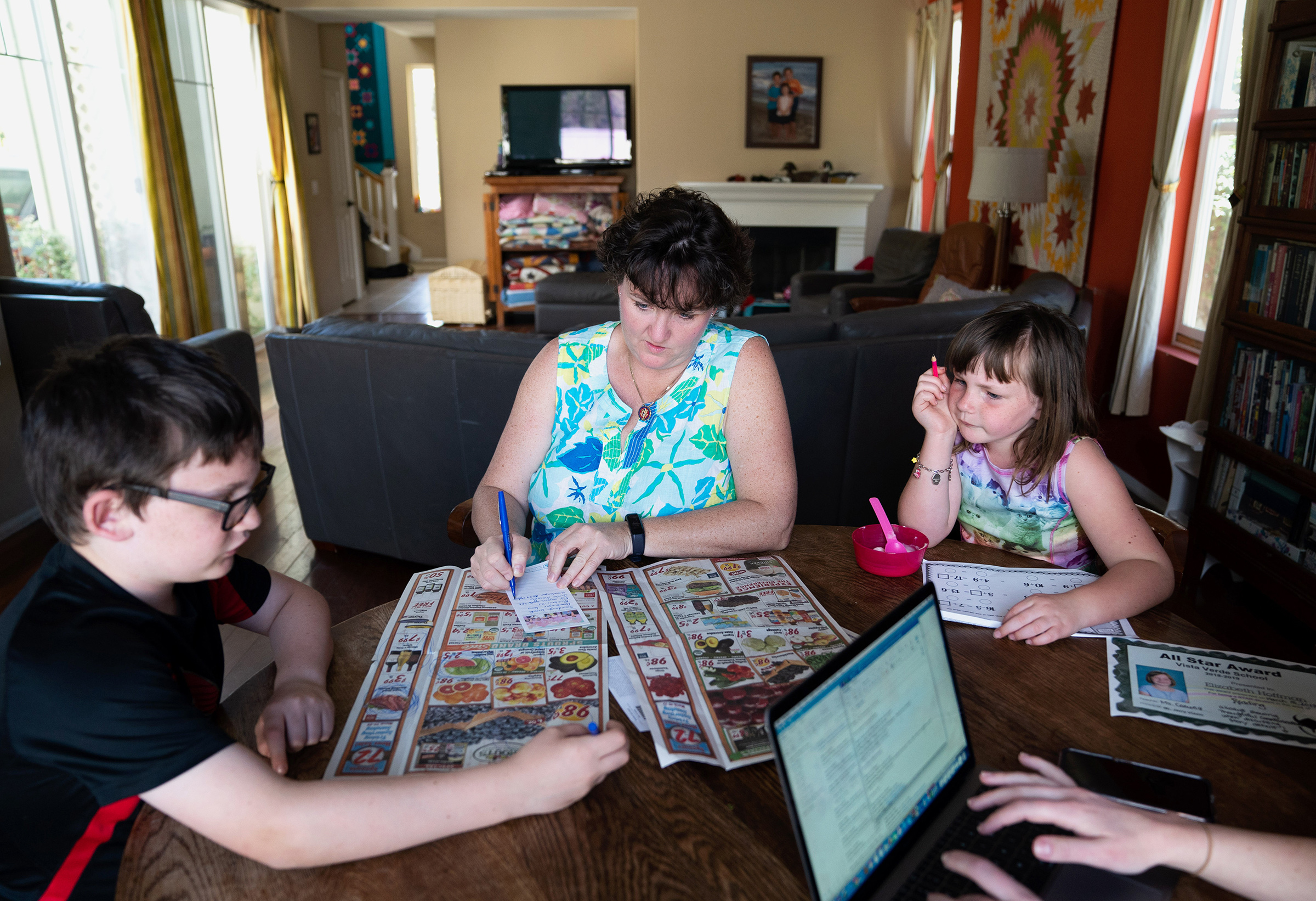 Rep. Katie Porter compiles a grocery shopping list with her son Paul and daughter Betsy at home in Irvine, Calif., on March 20, 2019
