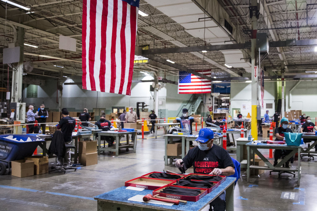 Workers wearing protective masks and gloves assembles face shields at the Cartamundi-owned Hasbro manufacturing facility in East Longmeadow, Massachusetts, U.S., on Wednesday, April 29, 2020. (Adam Glanzman—Bloomberg/Getty Images)