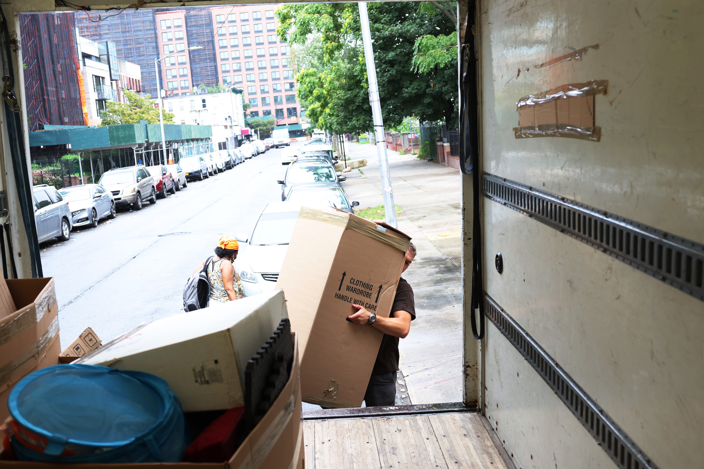 A mover with Rabbit Movers places the belongings of a customer unto a moving truck on Aug. 13, 2020 in New York City. Moving companies are increasingly trying to keep up with higher demand as an uptick of people are choosing to move from New York City during the COVID-19 pandemic. (Michael M. Santiago—Getty Images)