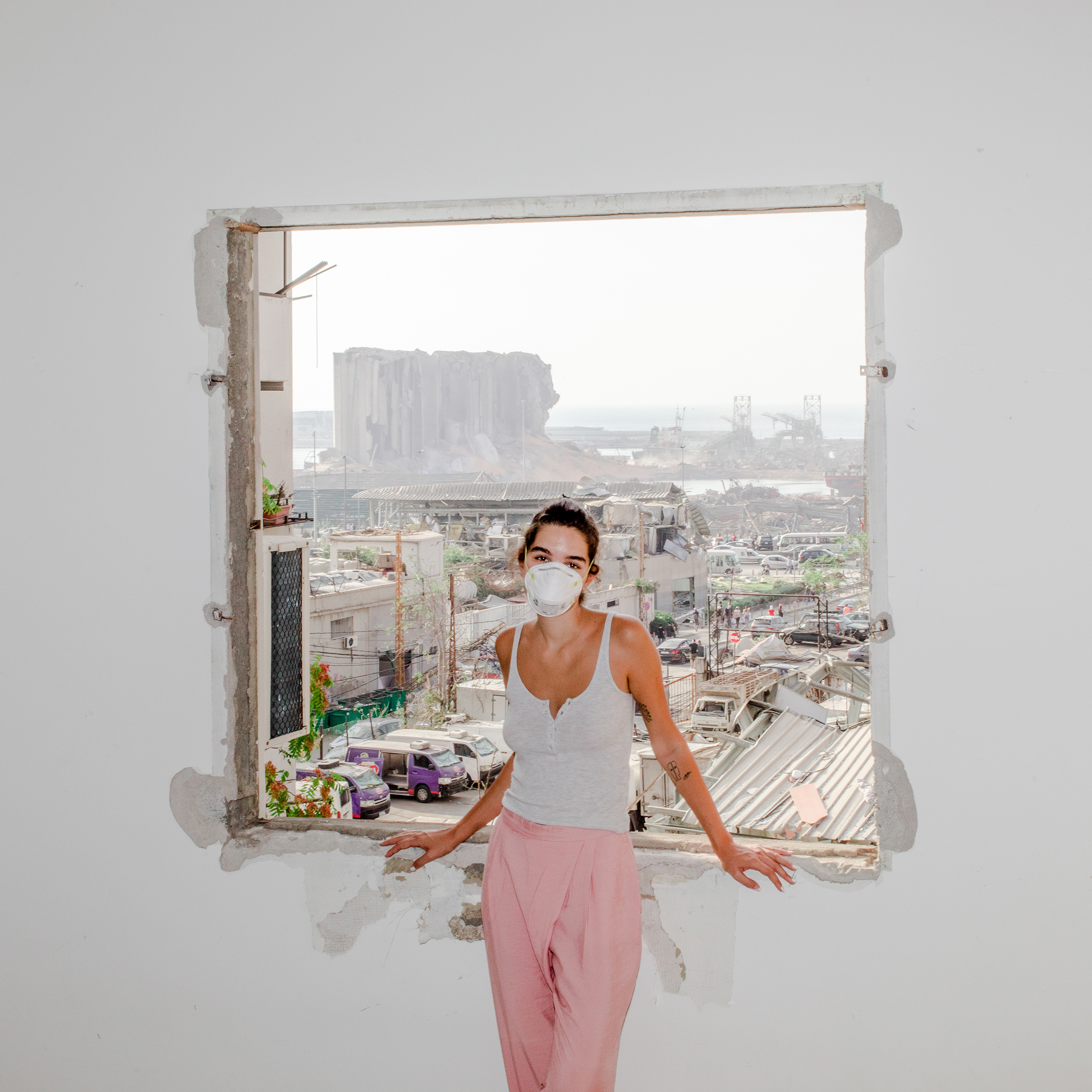 Nour Saliba stands in her apartment in the Mar Mikhael area of Beirut on Aug. 6, two days after the deadly explosion at the city’s port, seen through her blown-out window. “Honestly, I had it easy. I only lost my home. I am one of the lucky ones who still have their family and friends by their side,” says the 27-year-old community manager and model. “Trauma is written all over the fumes of this explosion. Yes, we are all traumatized, but we are also burnt out.