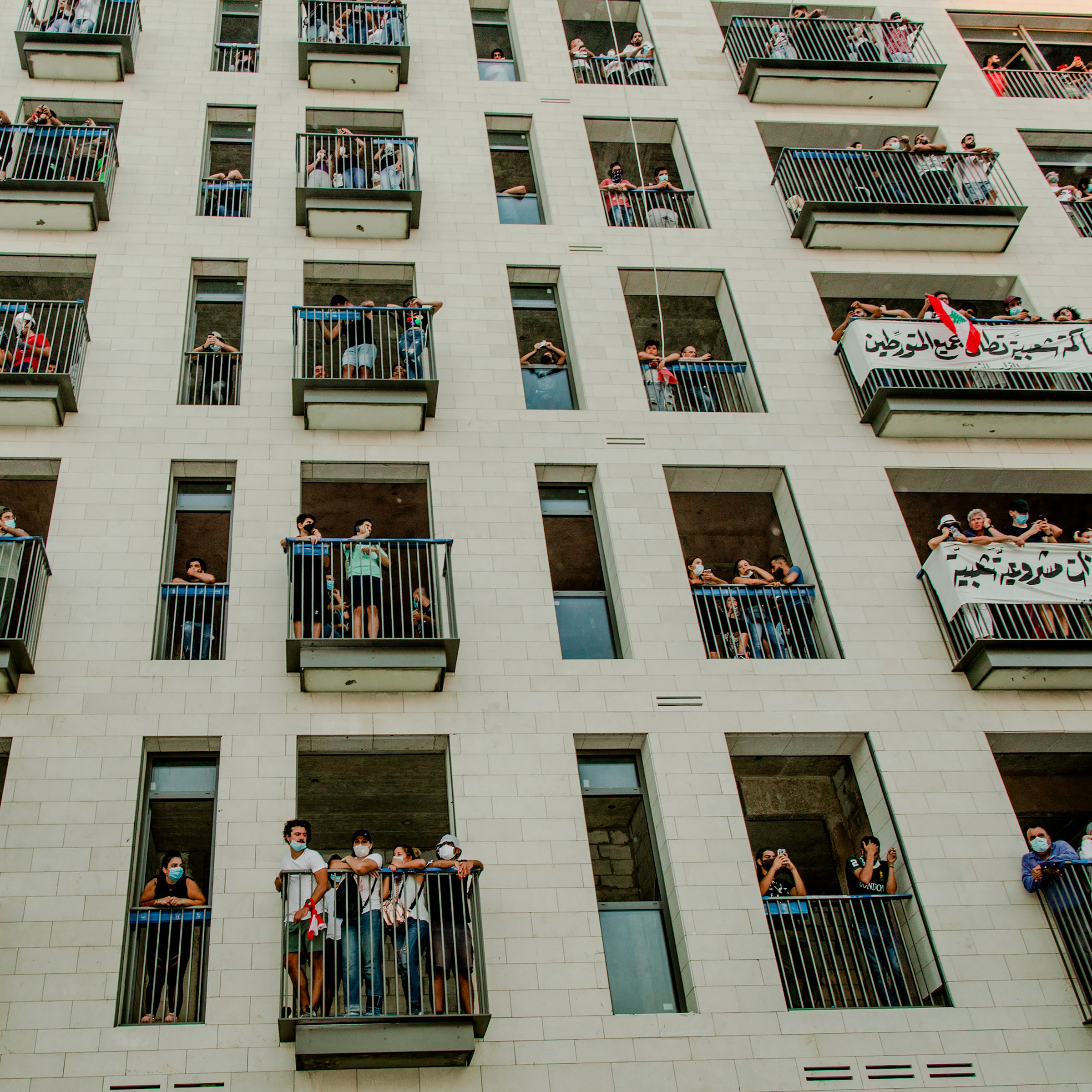 People gather on balconies during the Aug. 8 protest. Protesters say negligence and corruption across Lebanon's political system contributed to the port disaster.