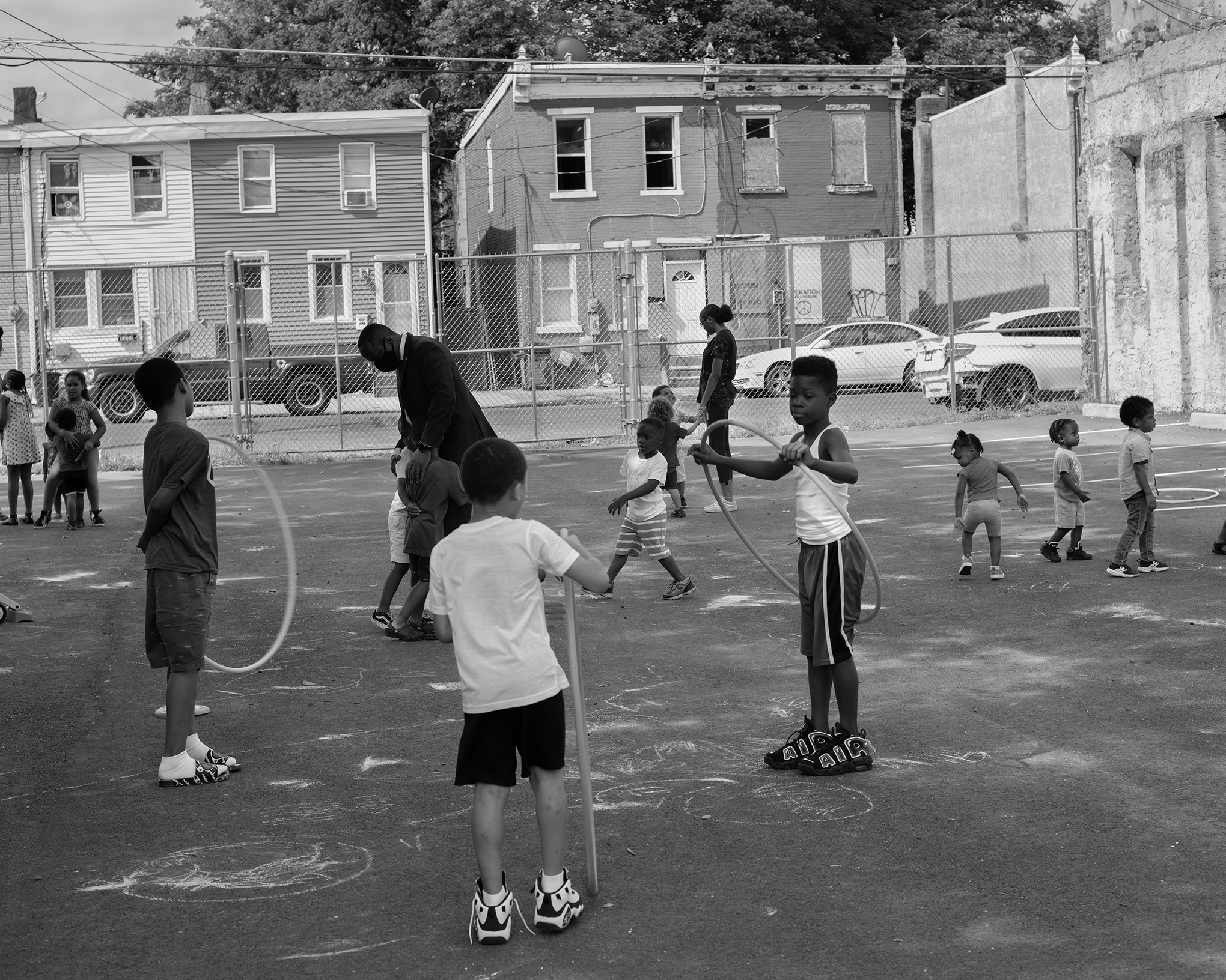 Minister Muhammad, who compares Camden’s old police department to a building so wrecked it was only worth tearing down, plays with children at Camden’s MEL Childcare Center, which is associated with his temple. (Widline Cadet for TIME)