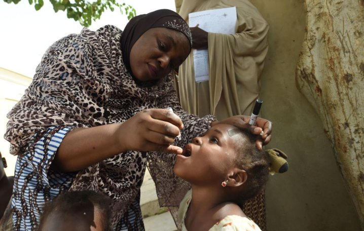 UNICEF health consultant Hadiza Waya immunizes a child during a polio vaccination campaign on April 22, 2017, in Kano, Nigeria.