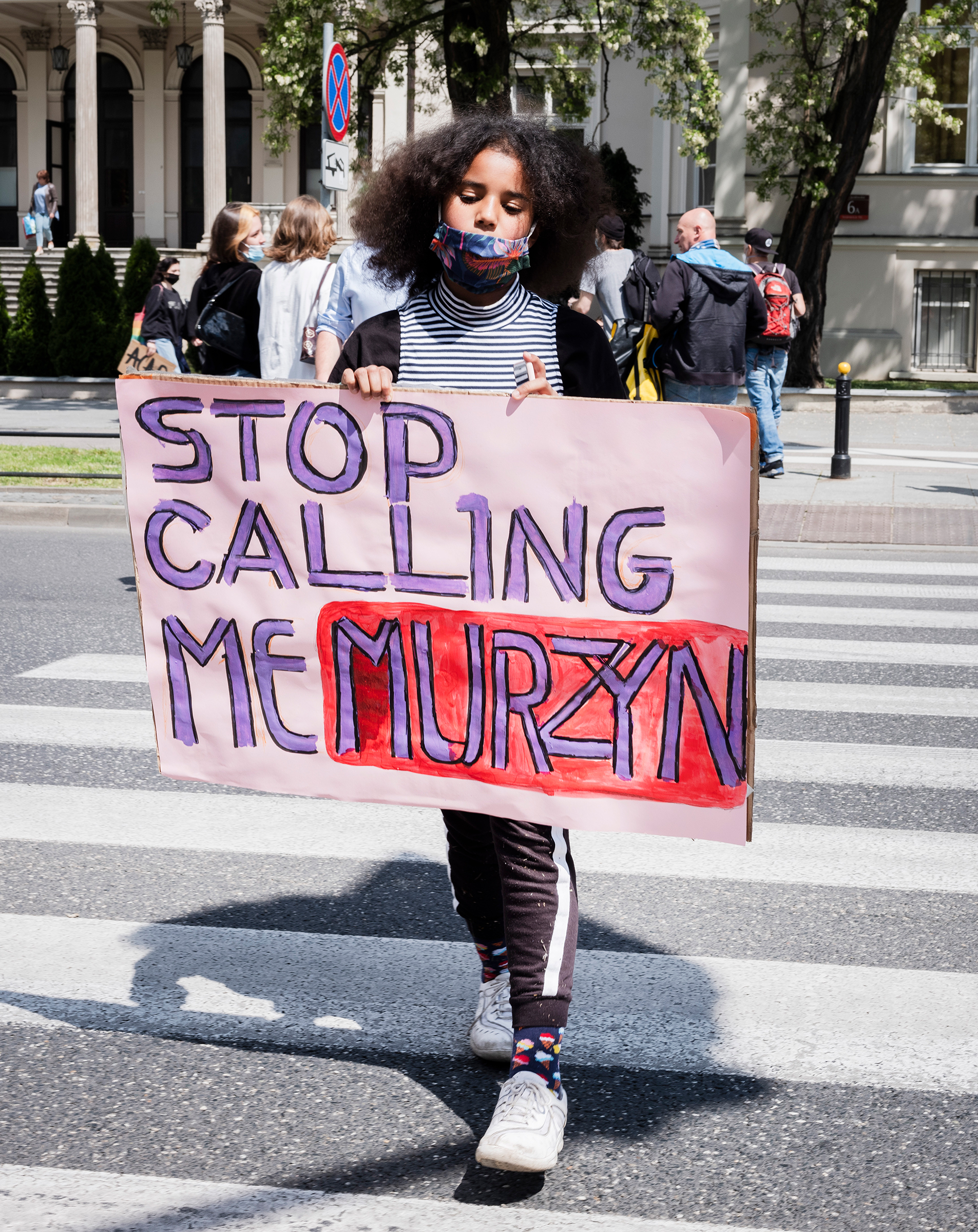 Bianka Nwolisa walks with a sign "Stop Calling Me Murzyn," during a protest against police brutality in the wake of George Floyd's killing, in Warsaw on June 4, 2020. (Rafal Milach—Magnum Photos)