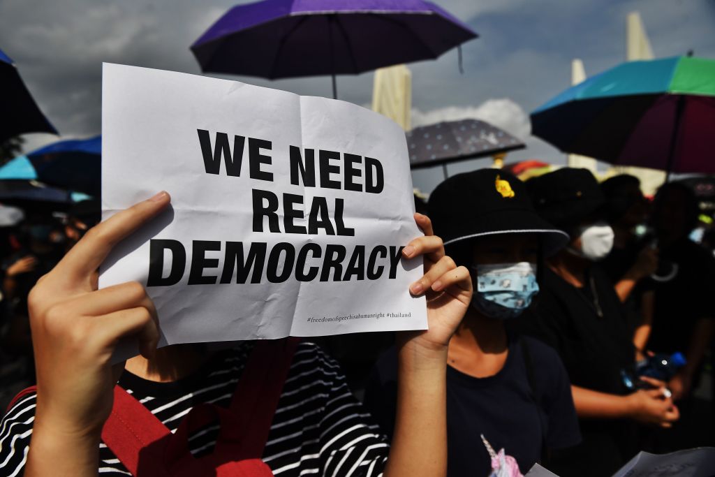 A protester holds up a sign at a rally in Bangkok, Thailand on Aug. 16, 2020. (LILLIAN SUWANRUMPHA—AFP/Getty Images)