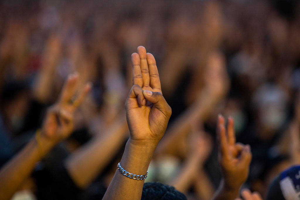 Protesters give a three-finger salute at a rally at the Democracy Monument in Bangkok, Thailand on Aug. 16, 2020. (Lauren DeCicca—Getty Images)