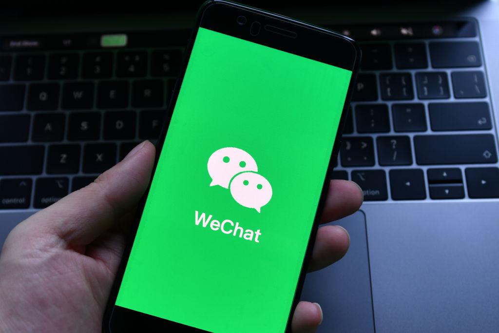 In this photo illustration, a WeChat logo seen displayed on