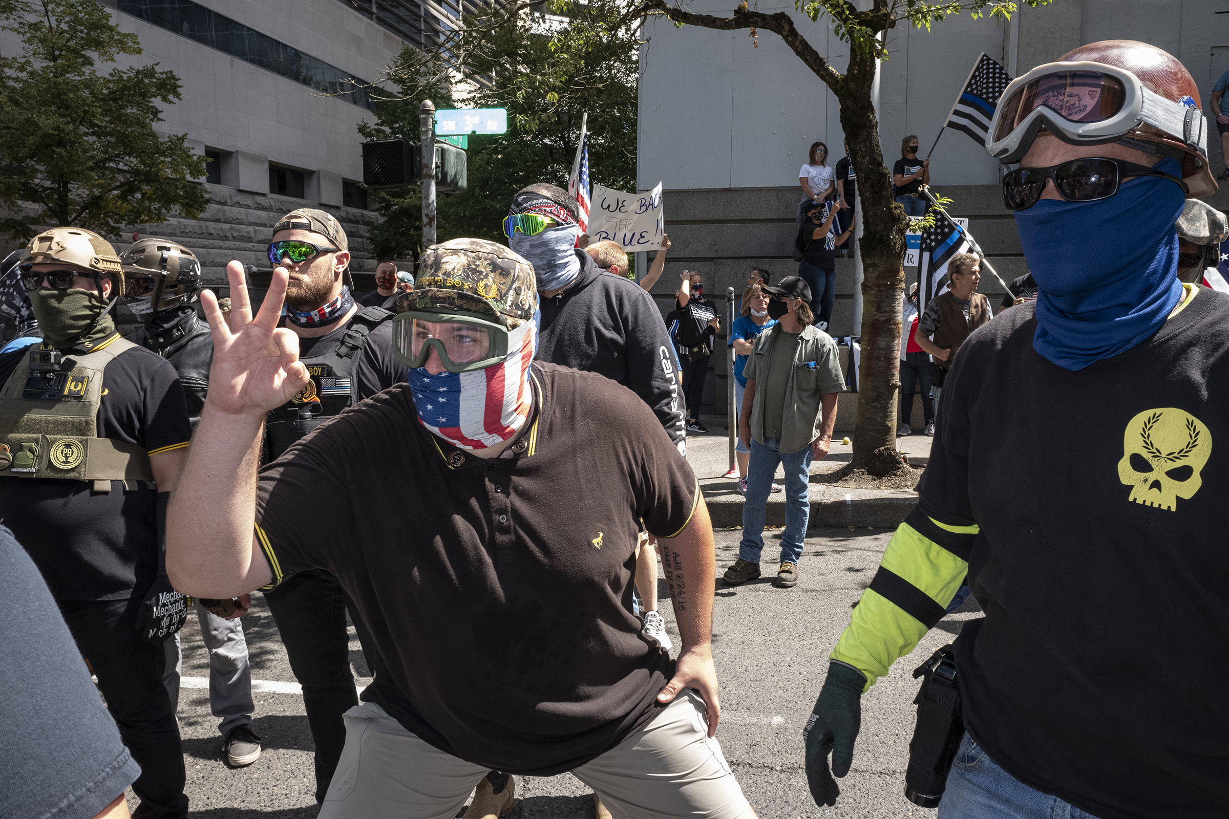 An associate of the Proud Boys, a far-right group with a history of engaging in violent street clashes, flashes the once innocuous “OK” hand sign—now co-opted by white supremacists—at counter demonstrators during a rally in Portland, Ore., Aug. 22, 2020. (Rian Dundon)