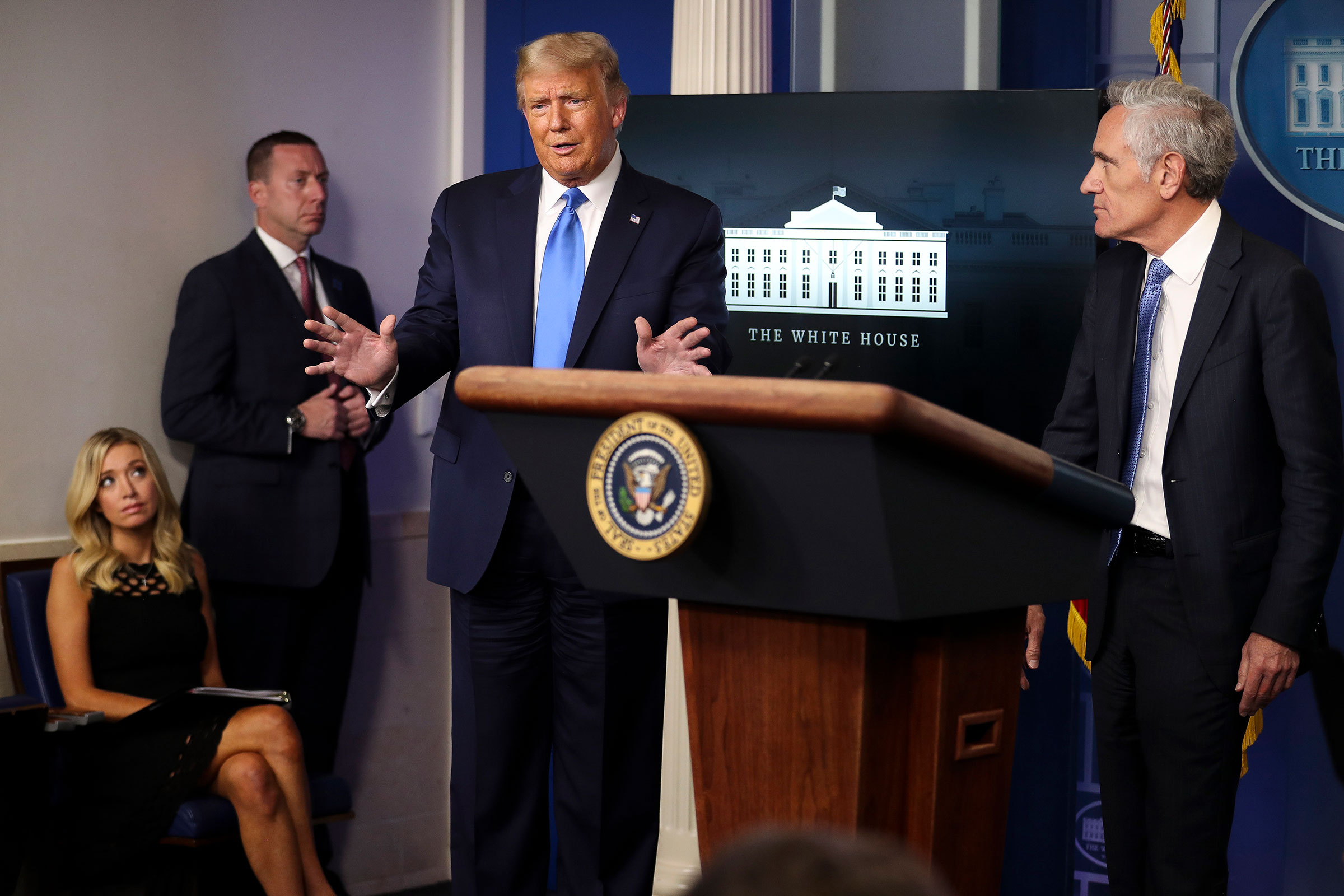 President Donald Trump speaks as Dr. Scott Atlas, a White House adviser on the coronavirus, right, and White House Press Secretary Kayleigh McEnany, far left, listen during a press briefing at the White House in Washington, on Wednesday, Sept. 23, 2020. (Oliver Contreras/The New York Times) (OLIVER CONTRERAS—New York Times/Redux)