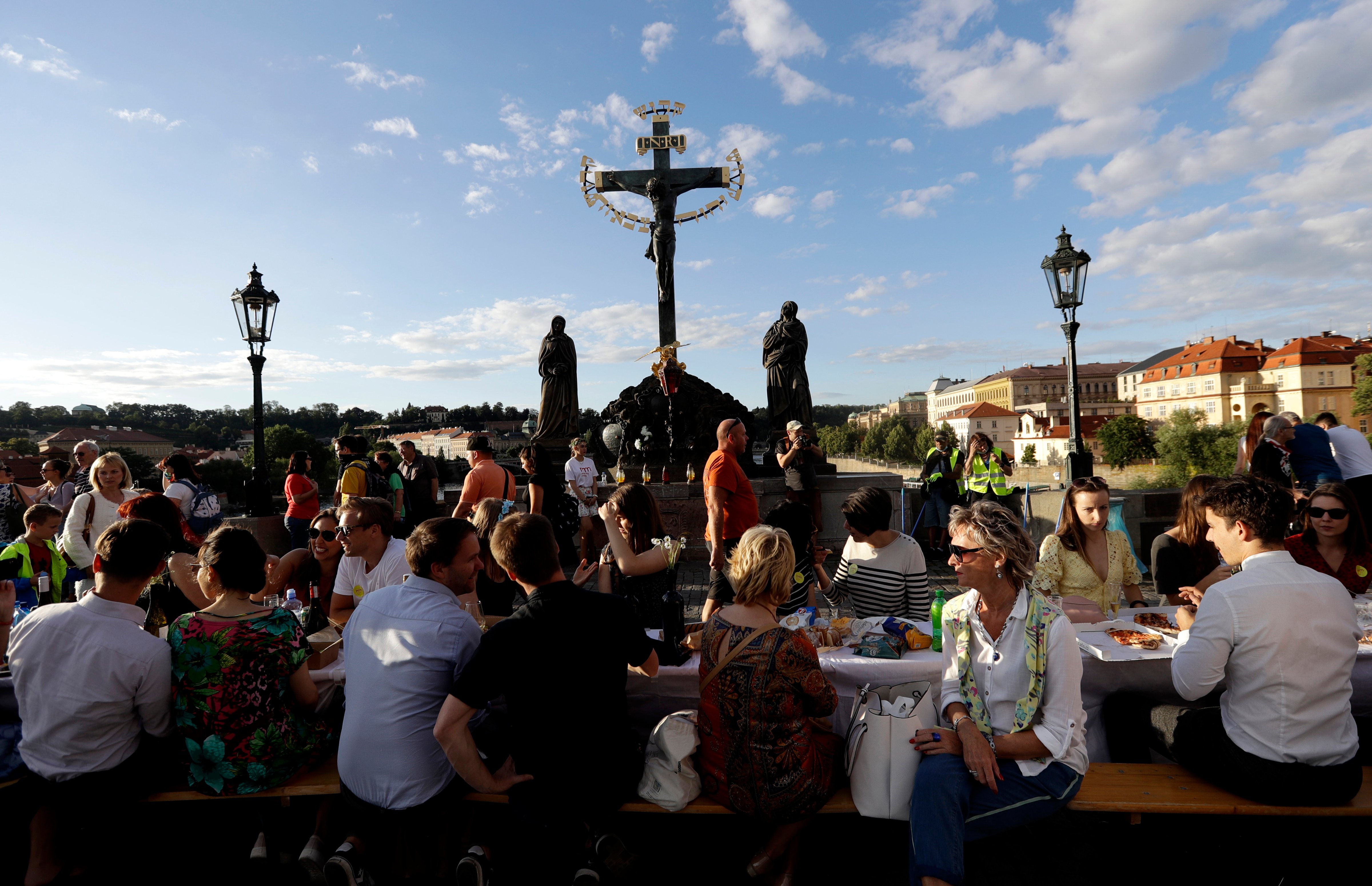 Residents sit to dine on a 500 meter long table set on the medieval Charles Bridge, after restrictions were eased following the coronavirus pandemic in Prague, Czech Republic, Tuesday, June 30, 2020. (Petr David Josek —AP Photo/Getty Images)