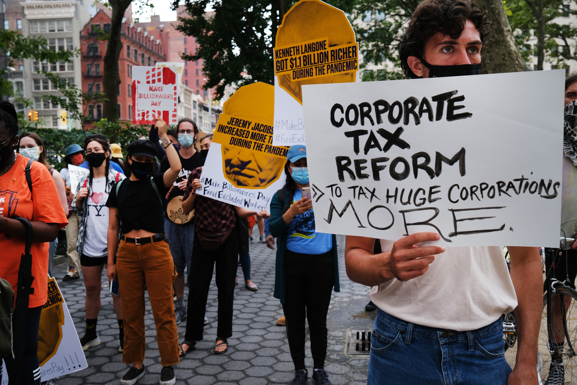 People participate in a "March on Billionaires" event on July 17 in New York City.