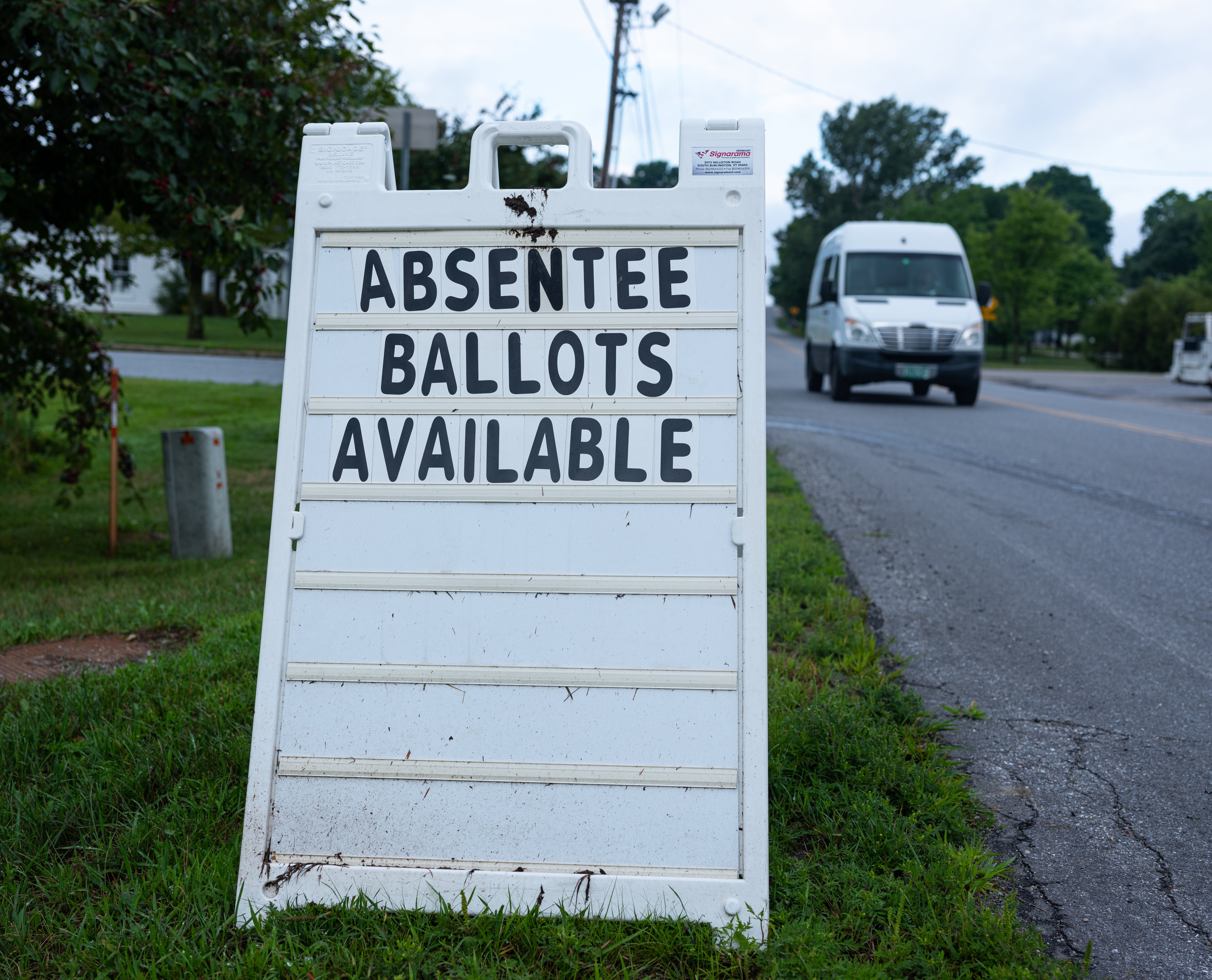 A street sign announces availability of absent ballots for the Vermont primary voting outside of the Town Hall on Aug. 10, 2020 in Charlotte, Vermont. Most states do not have accessible absentee ballot systems. (Robert Nickelsberg—Getty Images)
