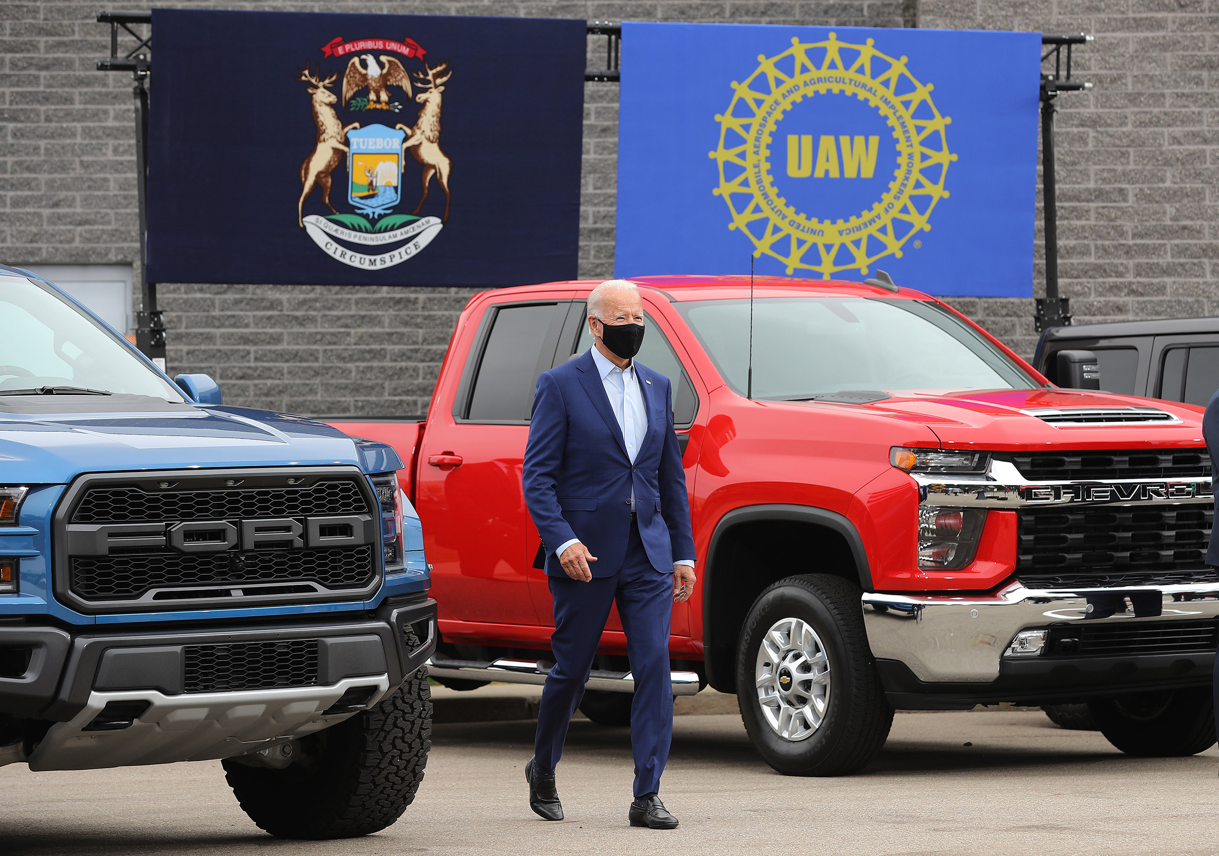 Democratic presidential nominee and former Vice President Joe Biden walks out in between pickup trucks before delivering remarks in the parking lot outside the United Auto Workers Region 1 offices in Warren, Mich., on Sept. 09, 2020. (Chip Somodevilla—Getty Images)