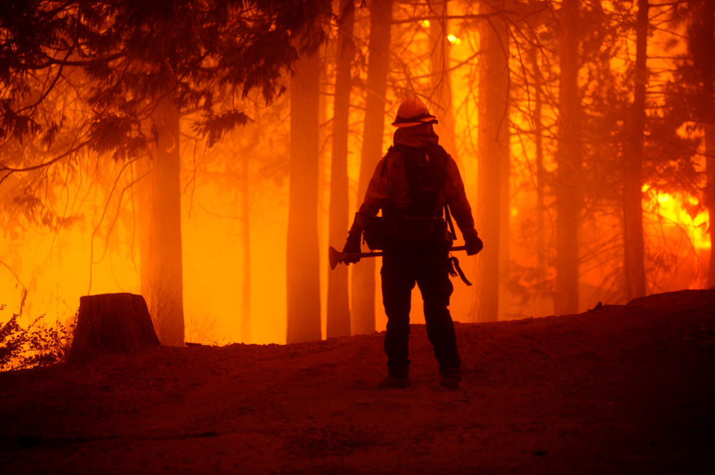 A firefighter fights against the Creek Fire which started Friday afternoon, blew up and grew to 73,278 acres on September 06, 2020, in Shaver Lake, Fresno County, California, United States. (Photo by Neal Waters/Anadolu Agency via Getty Images)