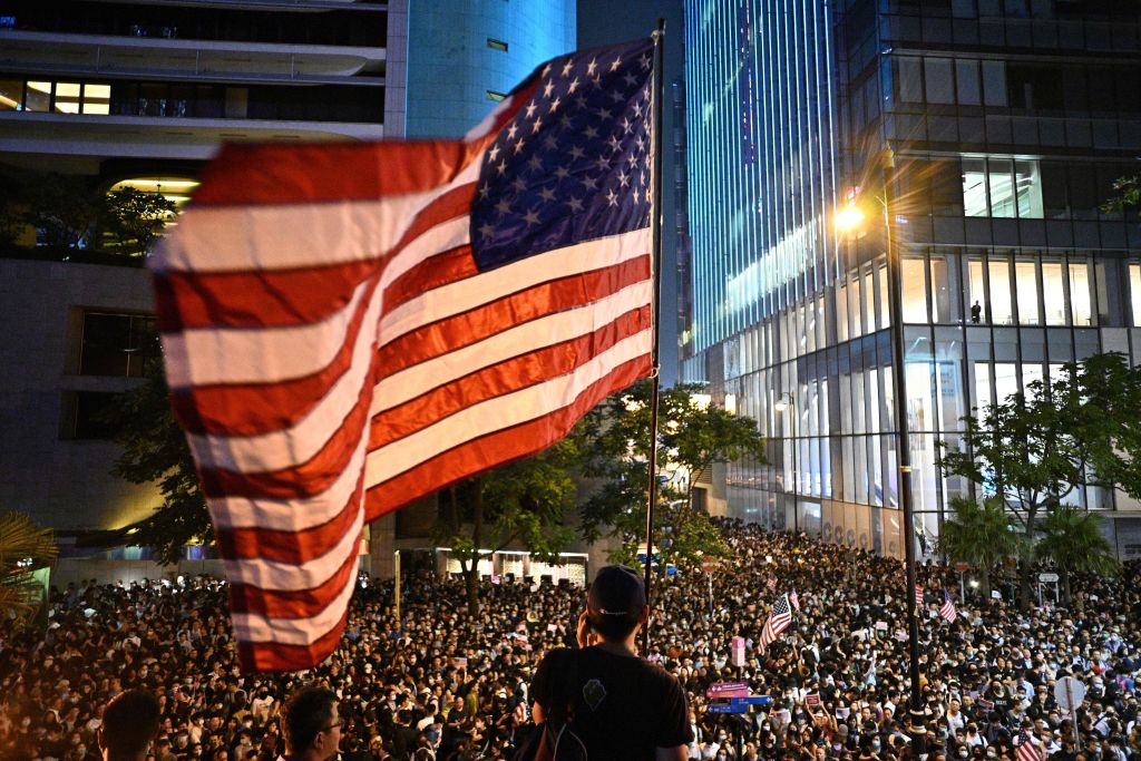 A man waves a US national flag as protesters attend a rally in Hong Kong on October 14, 2019. (ANTHONY WALLACE/AFP via Getty Images)