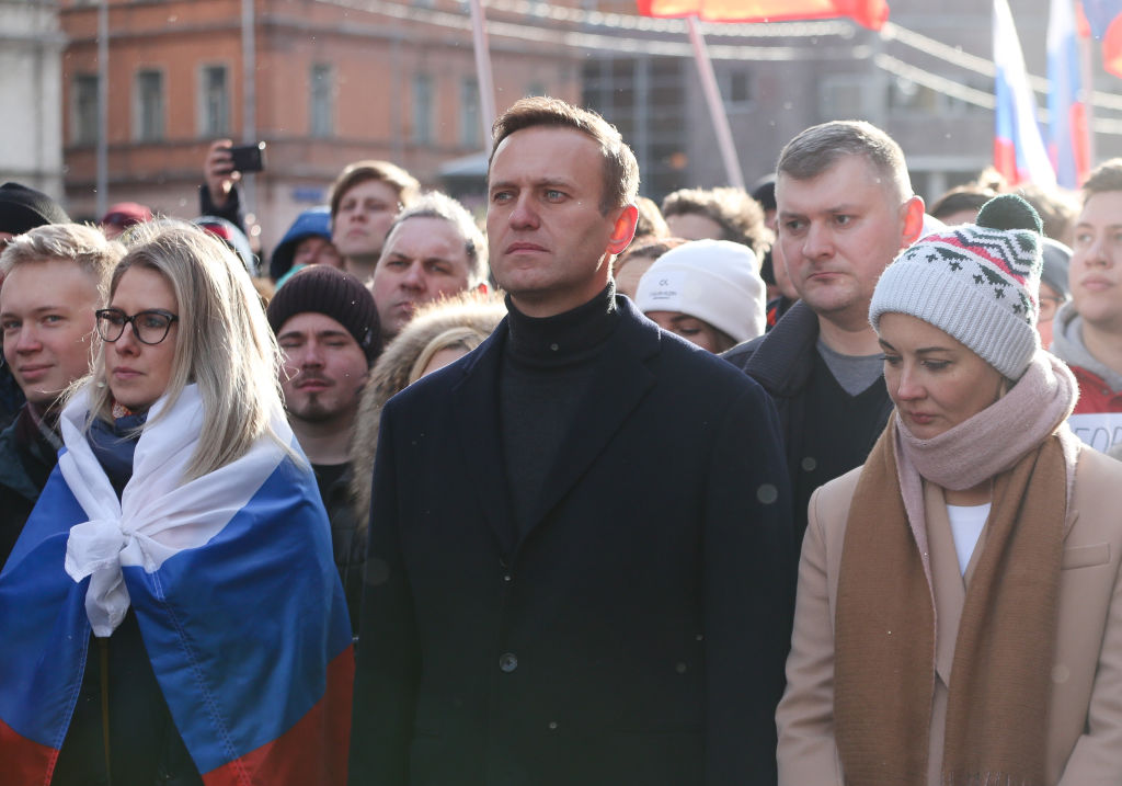 Navalny, center, and his wife Yulia, right, walk with demonstrators during a rally in Moscow in February 2019.