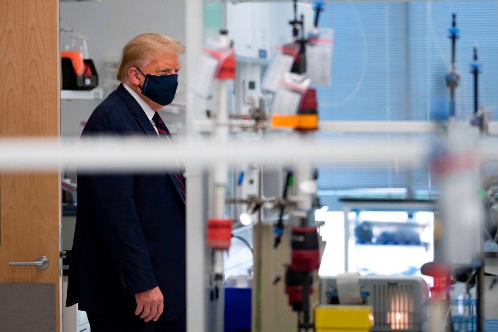 US President Donald Trump wears a mask as he tours a lab where they are making components for a potential vaccine at the Bioprocess Innovation Center at Fujifilm Diosynth Biotechnologies in Morrisville, North Carolina on July 27, 2020. (Jim Watson — AFP/Getty Images)