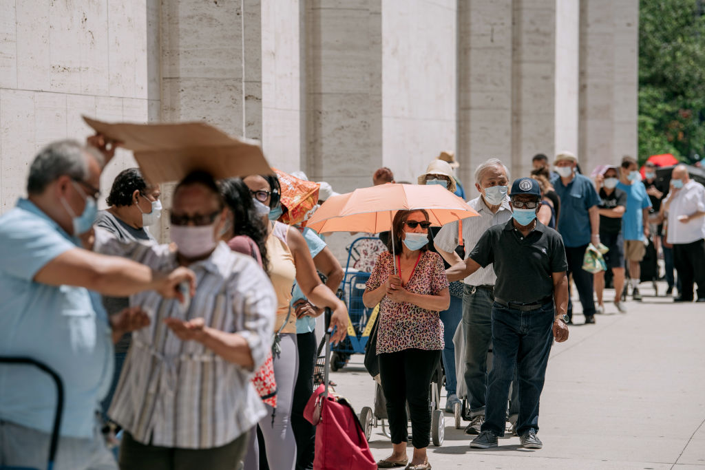 New Yorkers in need wait in a long line to receive free produce, dry goods, and meat at a Food Bank For New York City distribution event at Lincoln Center in New York City on July 29, 2020. (Scott Heins—Getty Images)