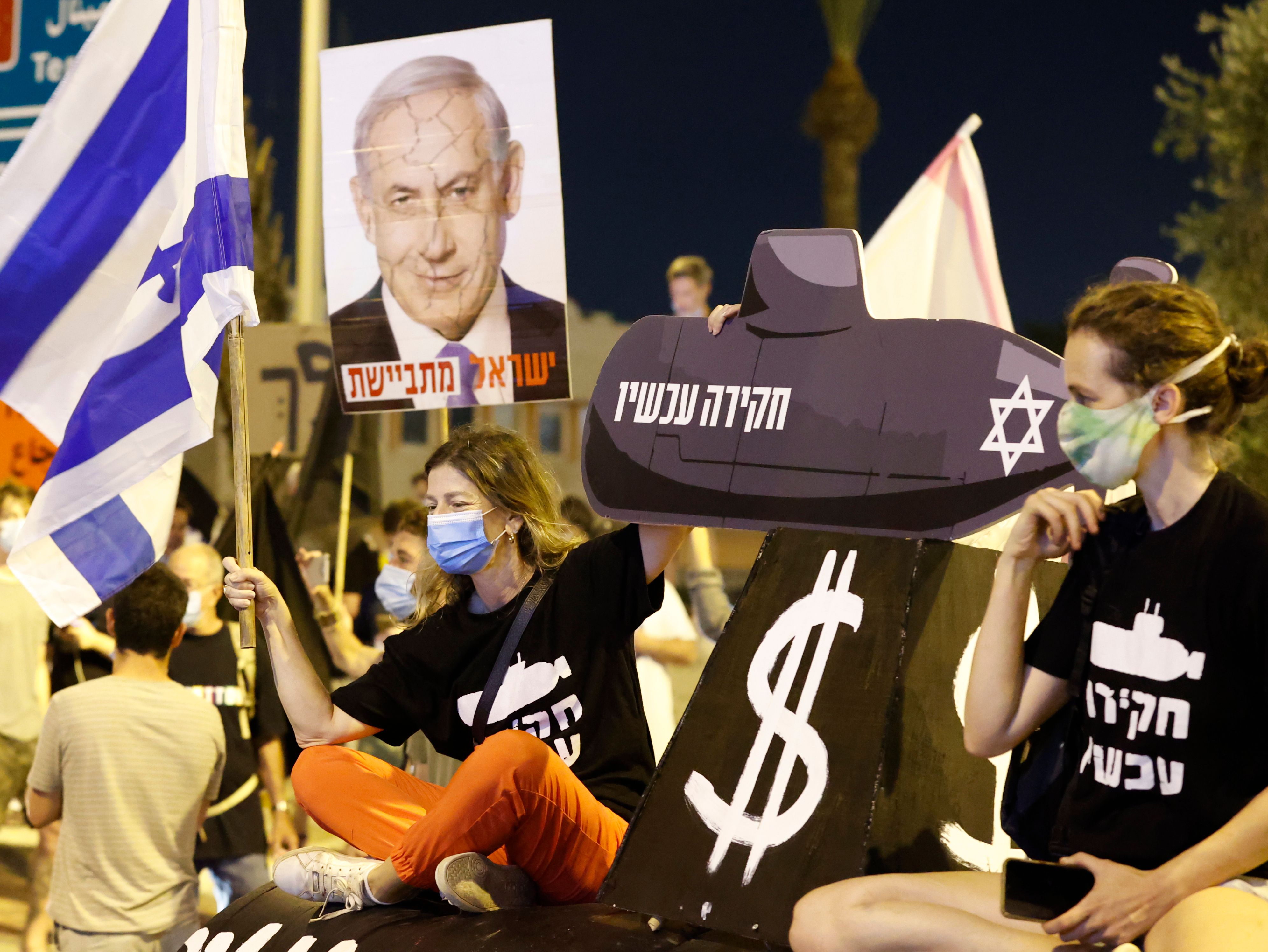 Israeli protesters take part in an anti-government demonstration outside the Ben Gurion Airport near Tel Aviv on September 13, 2020, demanding the resignation of Prime Minister Benjamin Netanyahu over several corruption indictments and his handling of the coronavirus crisis. (Jack Guez—AFP/Getty Images)