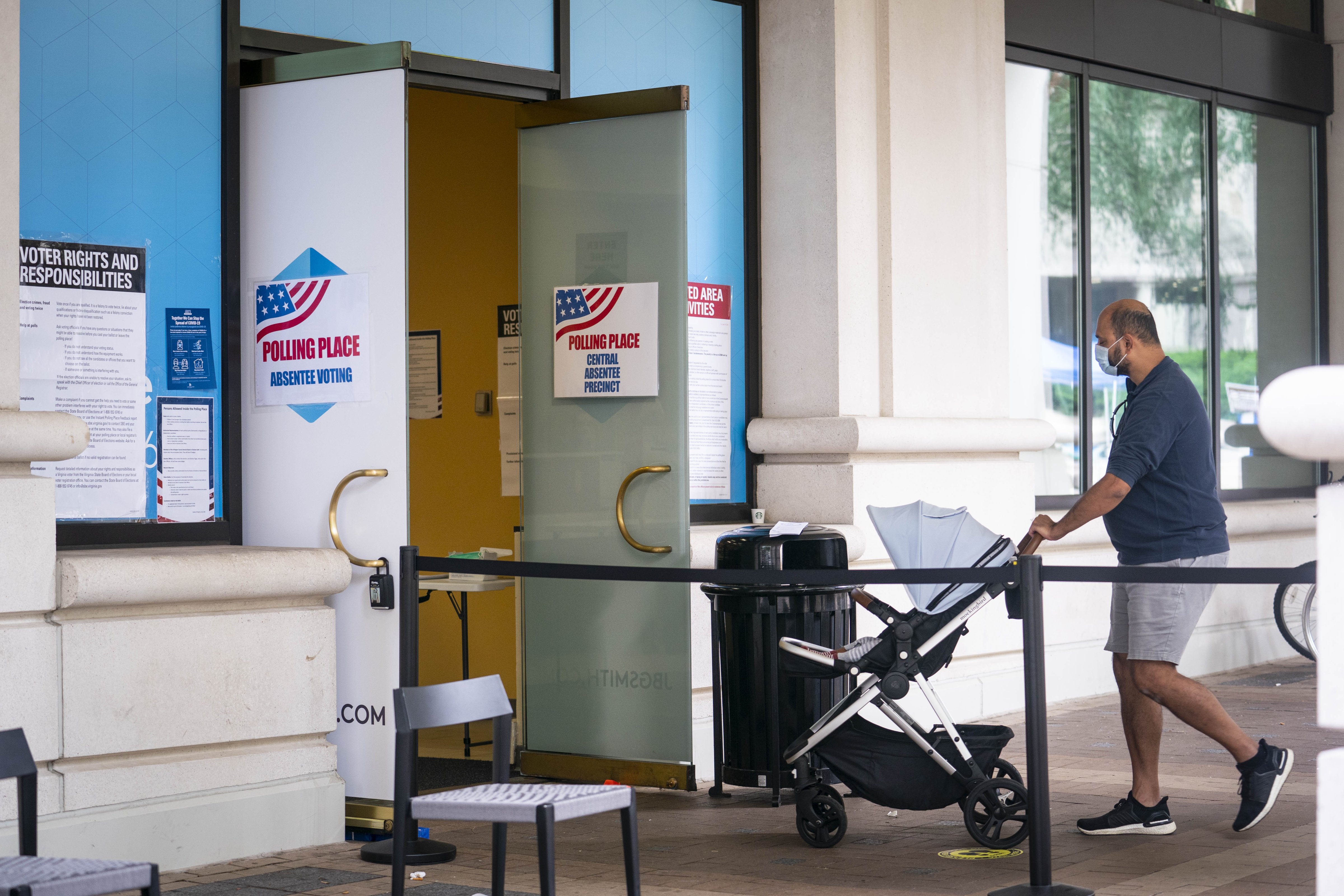 A voter wears a protective mask while entering an early voting polling location for the 2020 Presidential elections in Arlington, Virginia. on Sept. 18. (Sarah Silbiger—Bloomberg/Getty Images)