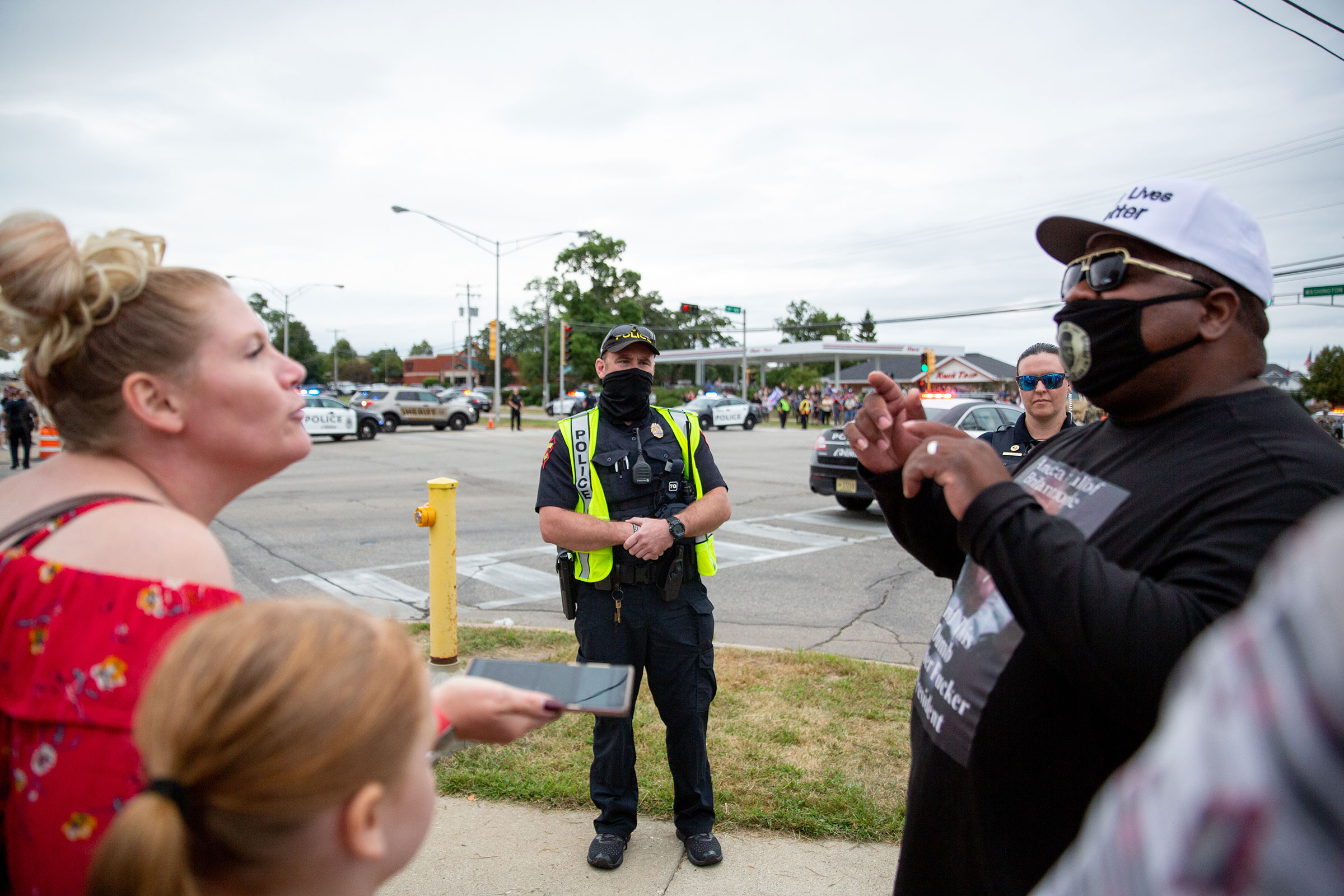 Police watch protestors during President Trump's meeting at Bradford High School in Kenosha, Wis., on Sept. 1, 2020. (Patience Zalanga for TIME)