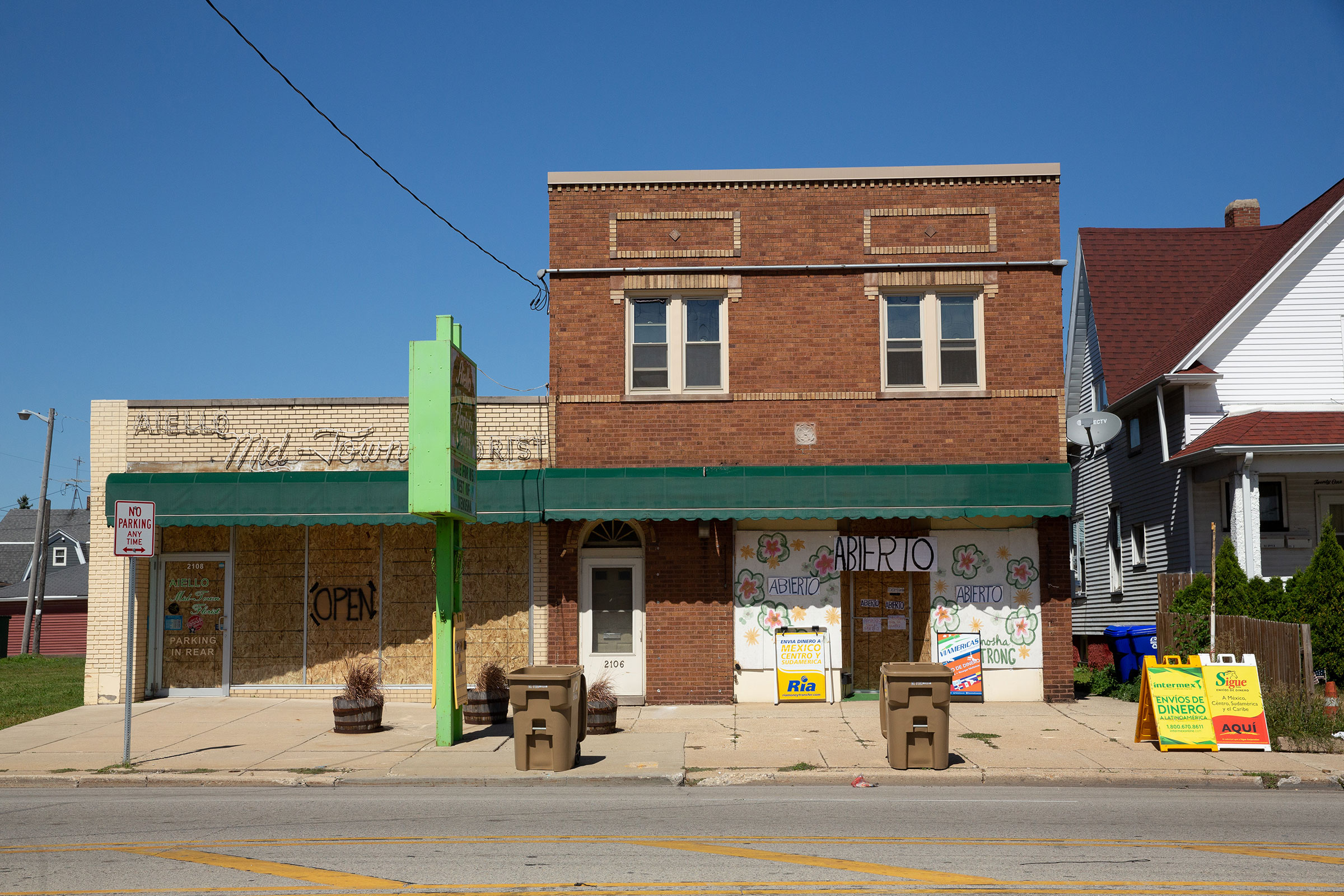 Boarded-up windows on businesses let patrons know they are still open in Kenosha, Wis., on Sept. 2, 2020. (Patience Zalanga for TIME)