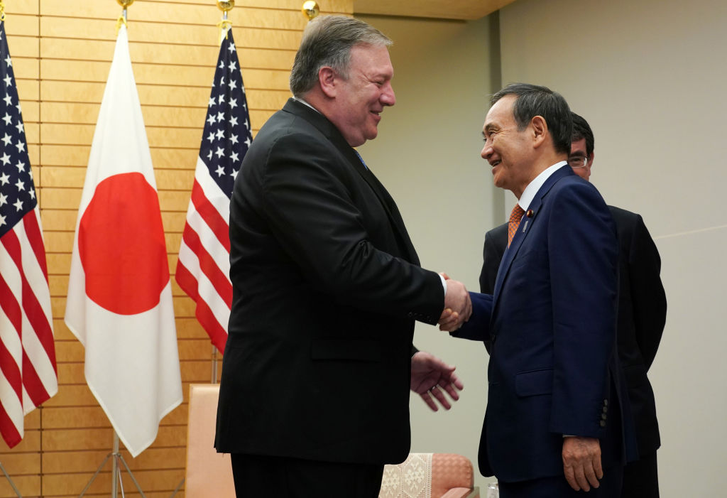 Secretary of State Mike Pompeo (L) speaks to Japan's then-Chief Cabinet Secretary Yoshihide Suga at the prime minister's office in Tokyo on Oct. 6, 2018. (Eugene Hoshiko—AFP/Getty Images)