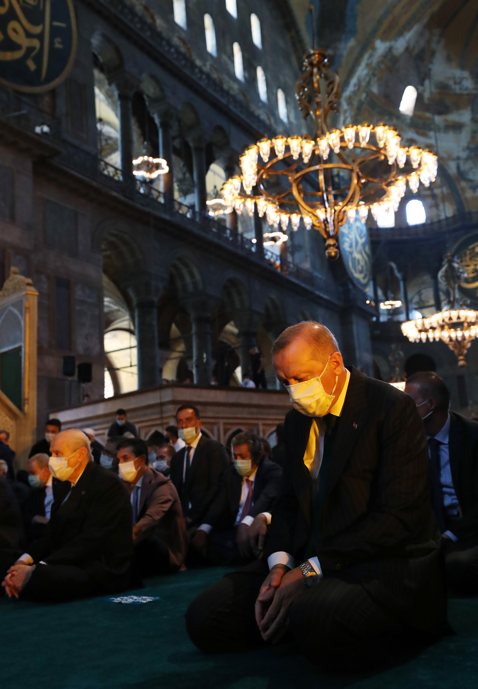 Turkey's President Recep Tayyip Erdogan (C) and invited guests attend Friday prayers at Hagia Sophia during the first official prayers after being reconverted into a mosque on July 24 (Handout/Turkish Presidential Press Office/Getty Images)