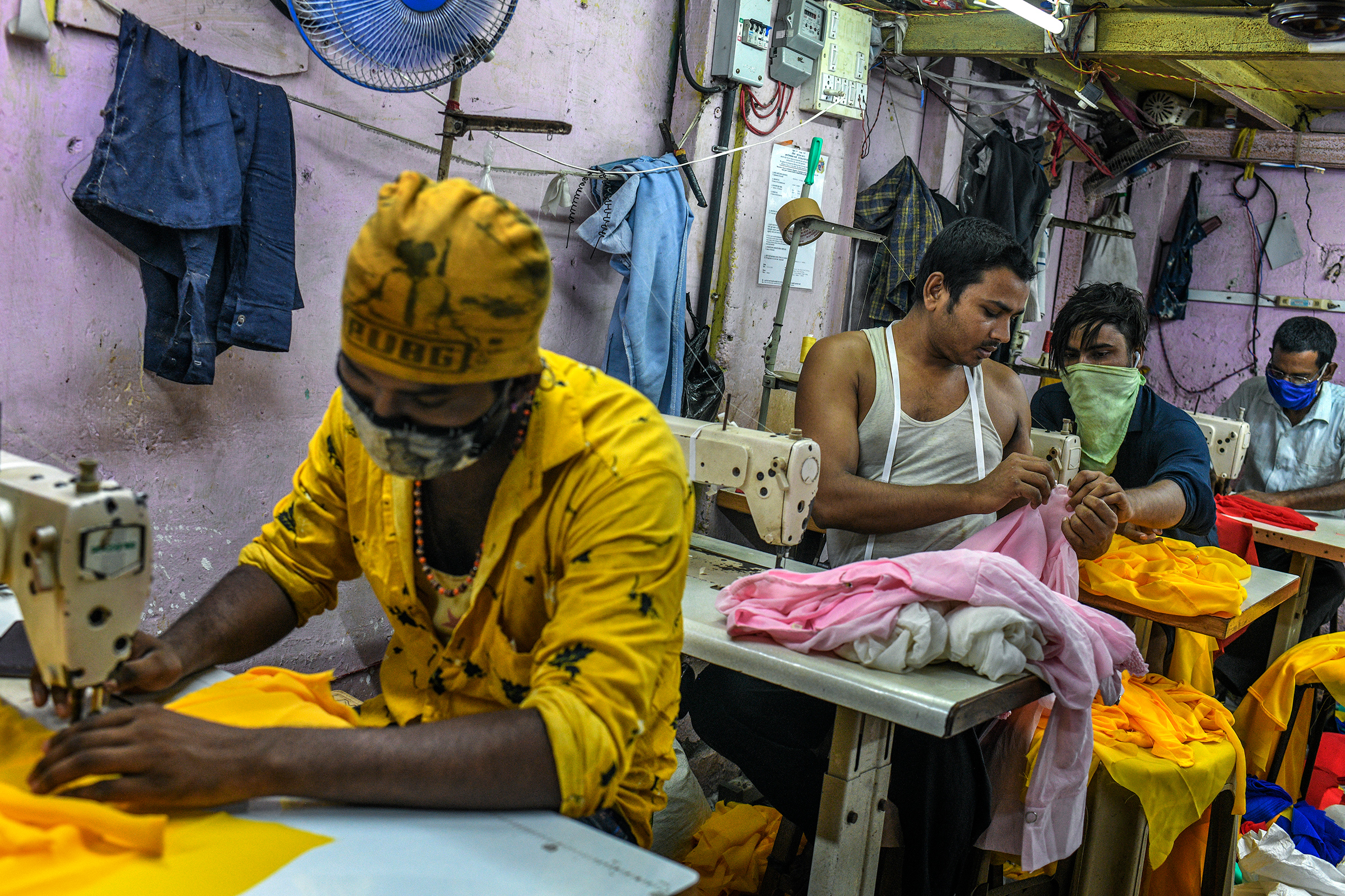 "My family was worried about the disease and didn’t want me to return to the city, but I had to come back to work," said Ishrar Ali, who stitches women's tops in a garment workshop in Dharavi.