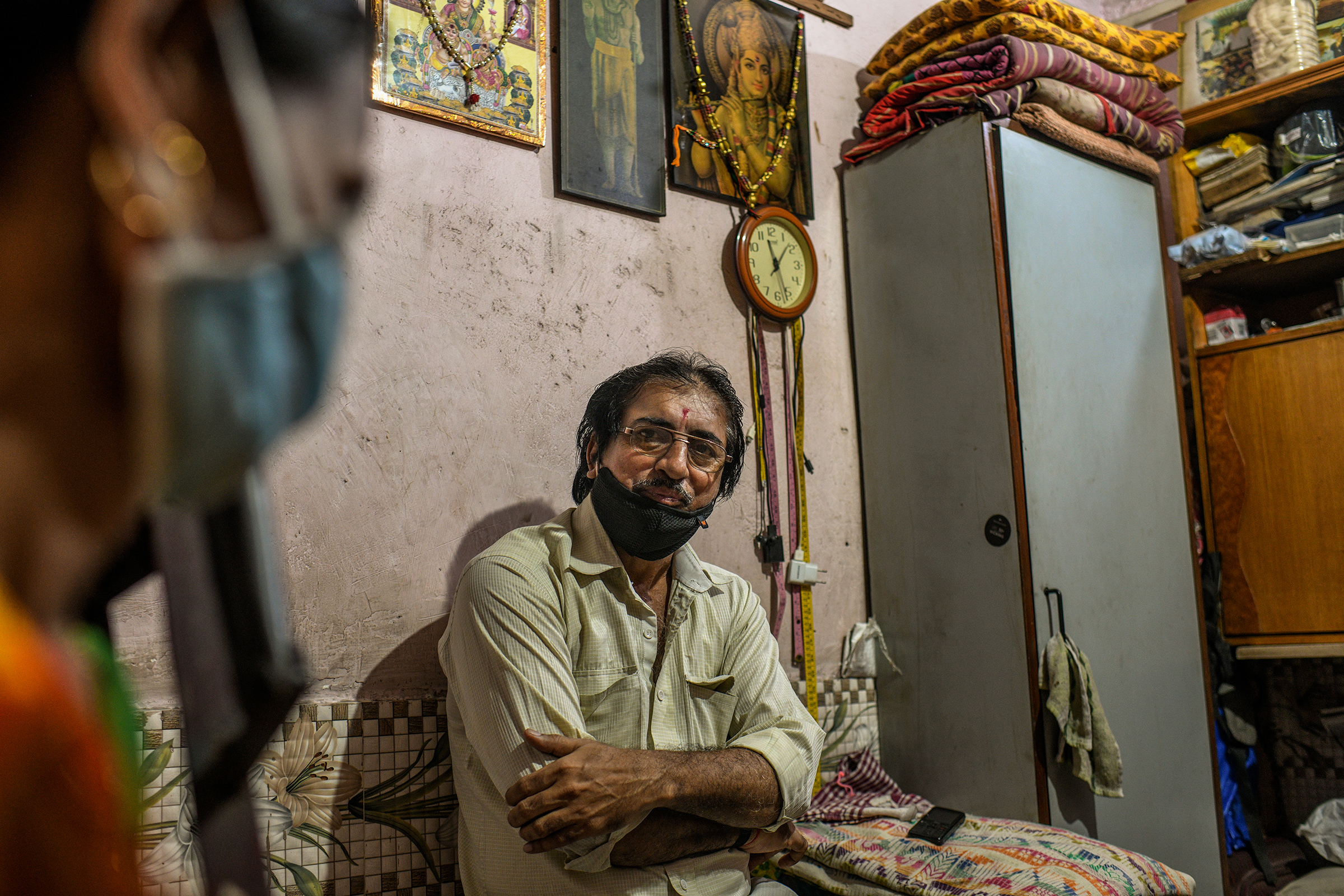 Jayanti Keshav Parmar, a tailor, at his home in Dharavi. His sewing machine sits idle, as no one in the neighborhood can afford to have new clothes stitched this year. (Atul Loke for TIME)