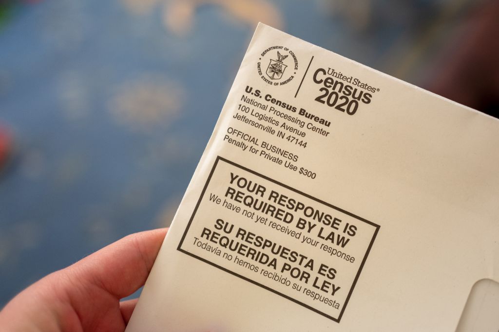 A hand holding a letter from the Census Bureau regarding the 2020 Census, San Ramon, Calif., April 24, 2020. (Gado / Getty Images)