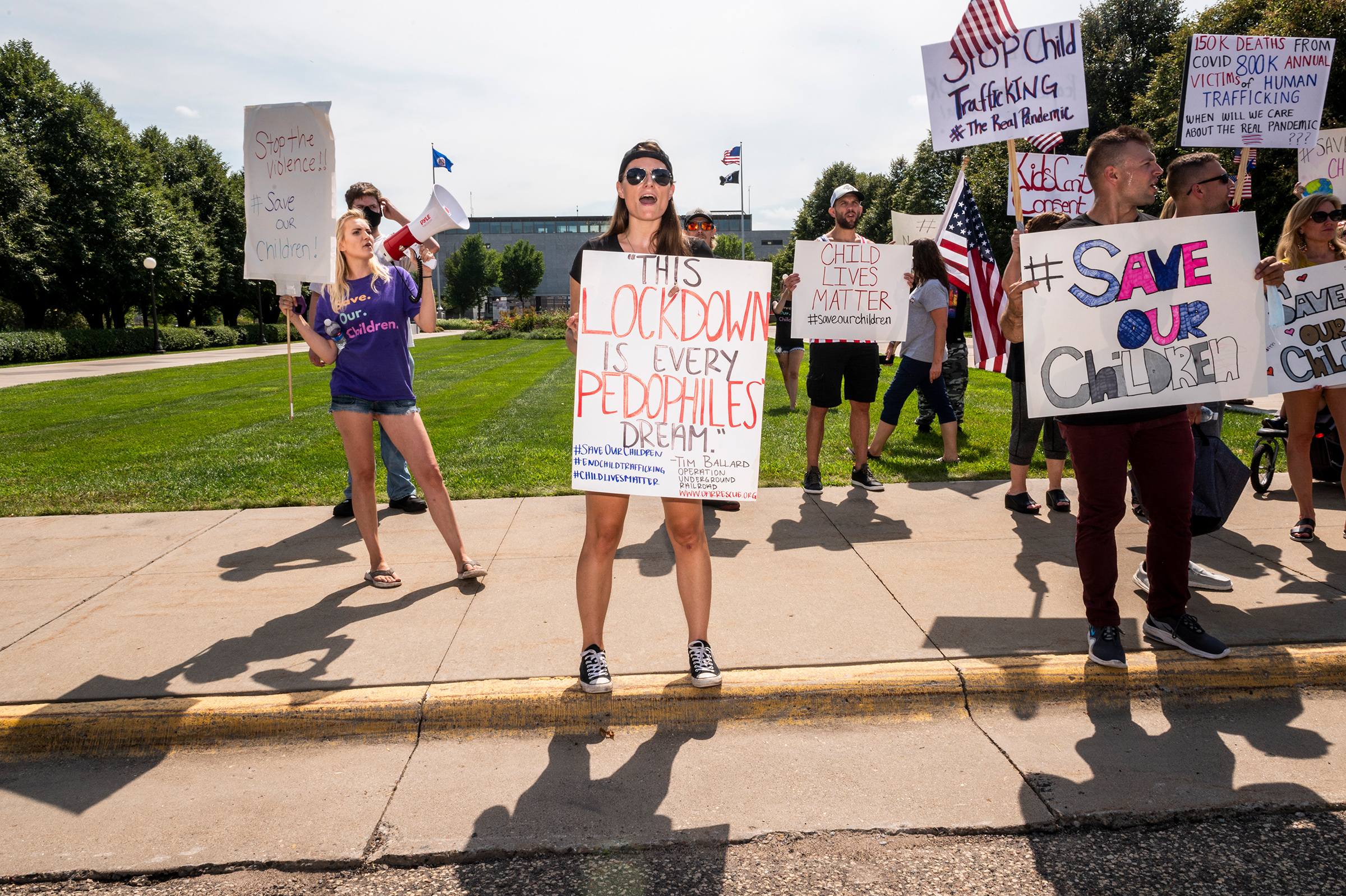 At an Aug. 22 “Save the Children” rally in St. Paul, Minn., protesters trumpet elements of the QAnon conspiracy theory (Stephen Maturen—Getty Images)