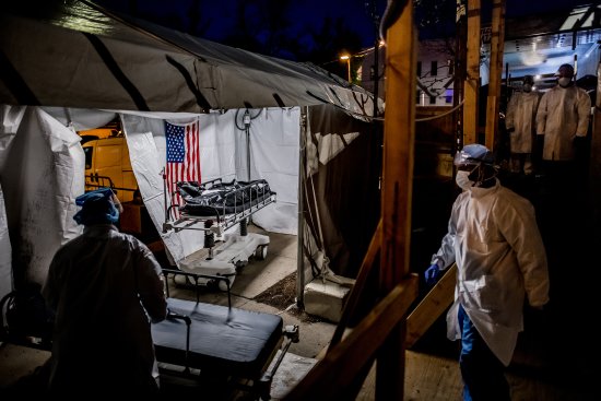 The transport team moves the body bags of deceased COVID-19 patients from the overflowing morgue of Brooklyn's Wyckoff Heights Medical Center into the improvised morgue set up outside on April 27. Three refrigerated semitrailers, capable of holding more than 150 bodies between them, were brought in as an emergency solution during the height of the pandemic. The transports often occurred at night to avoid upsetting neighbors of the hospital.