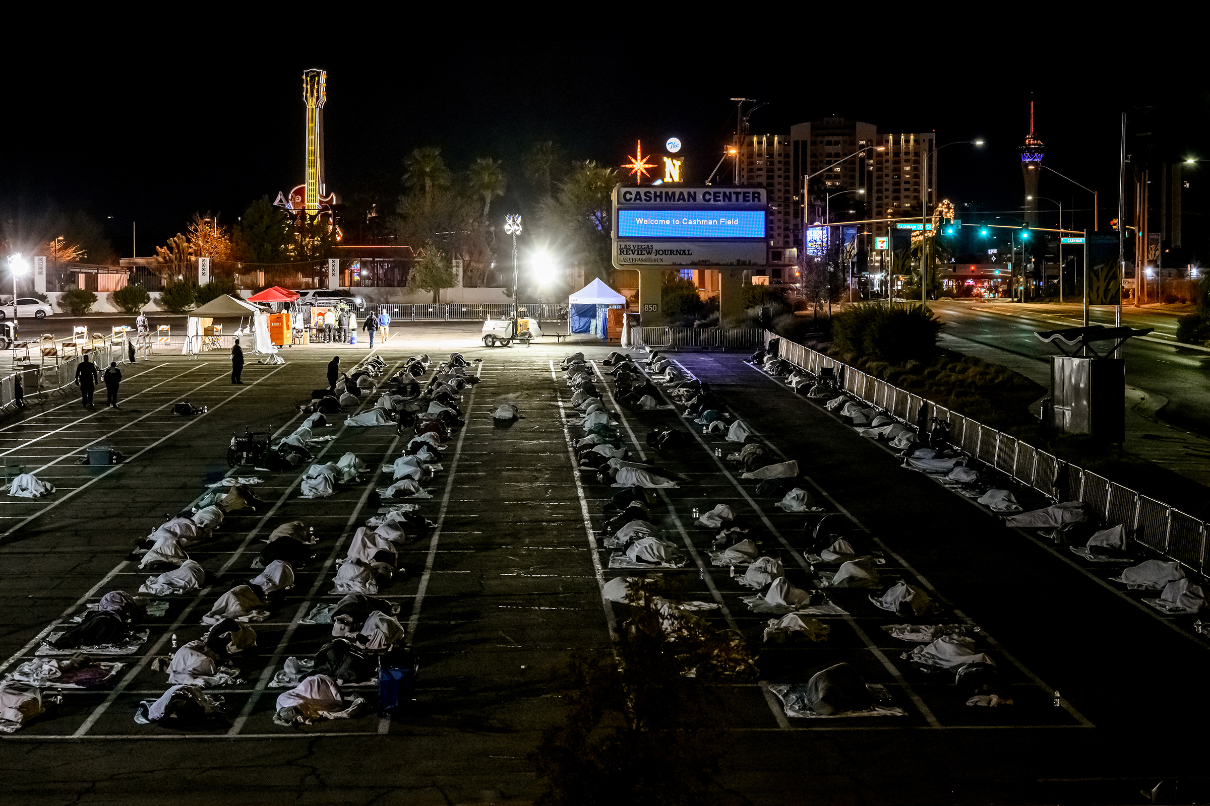 People sleeping in a parking lot in Las Vegas on March 30 after a homeless shelter shut down because of COVID-19 (Tod Seelie—The Guardian)
