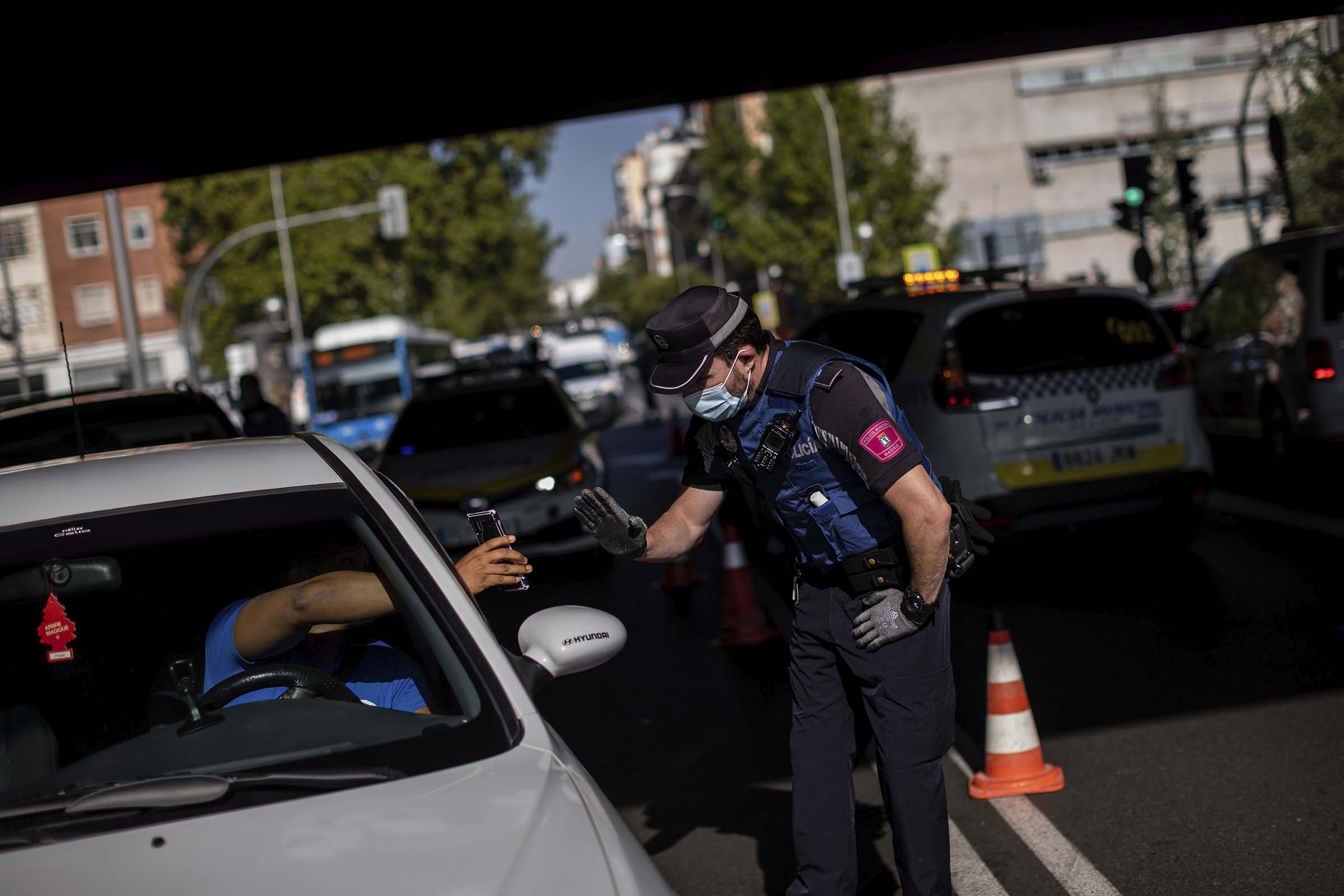 Local police stops a vehicle at a checkpoint in Madrid, Spain, on, Sept. 21, 2020. (Bernat Armangue—AP)