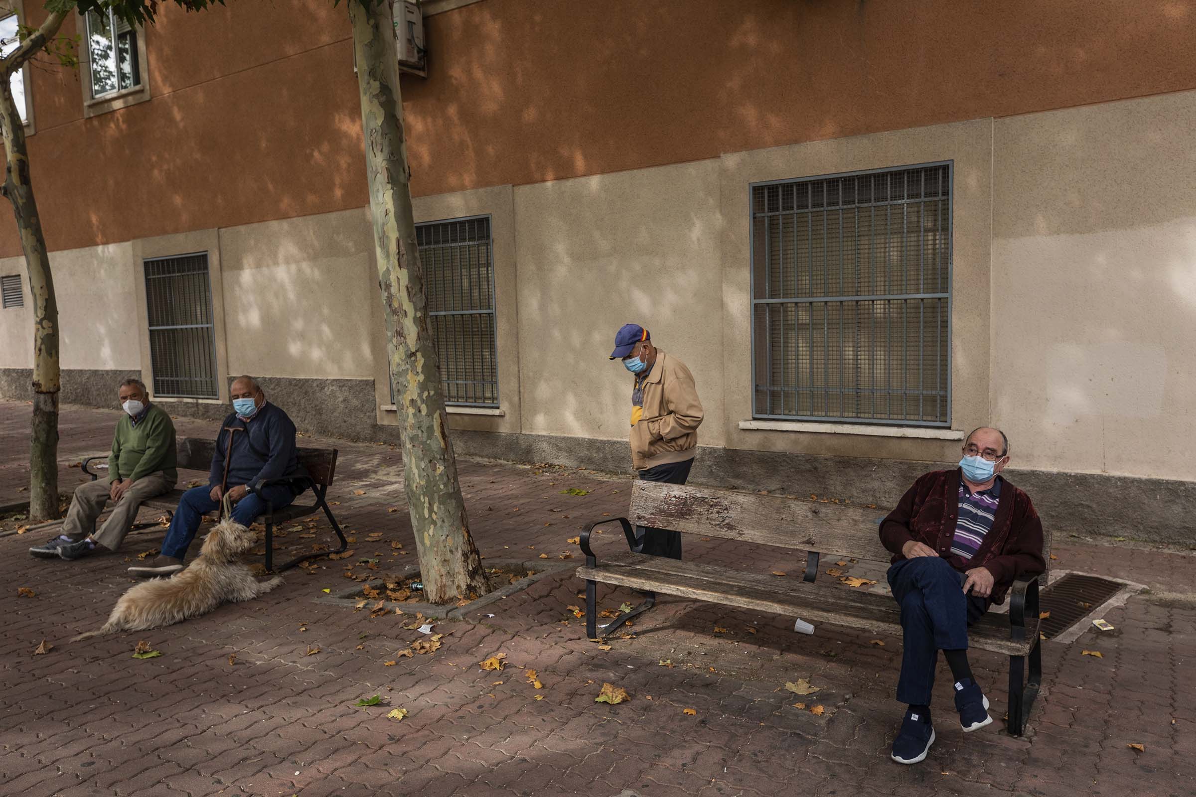 Elders wearing face masks to prevent the spread of the coronavirus sit on a park in Madrid, Spain, on Sept. 23, 2020. (Bernat Armangue—AP)