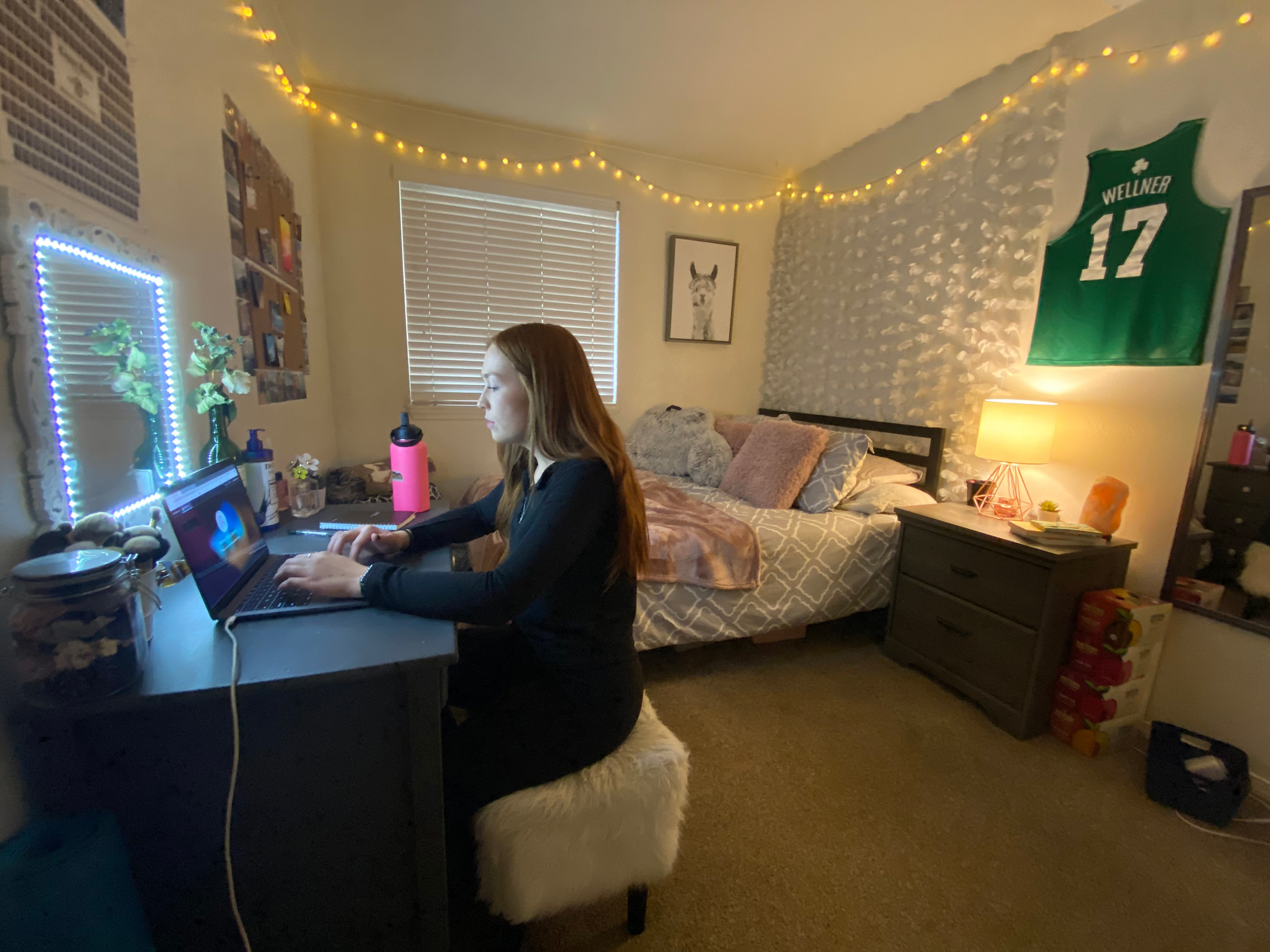 Molly Wellner, a student at Washington State University in Pullman, Wash., at her desk in her off-campus housing. Wellner and her roommates all tested positive for COVID-19 this fall